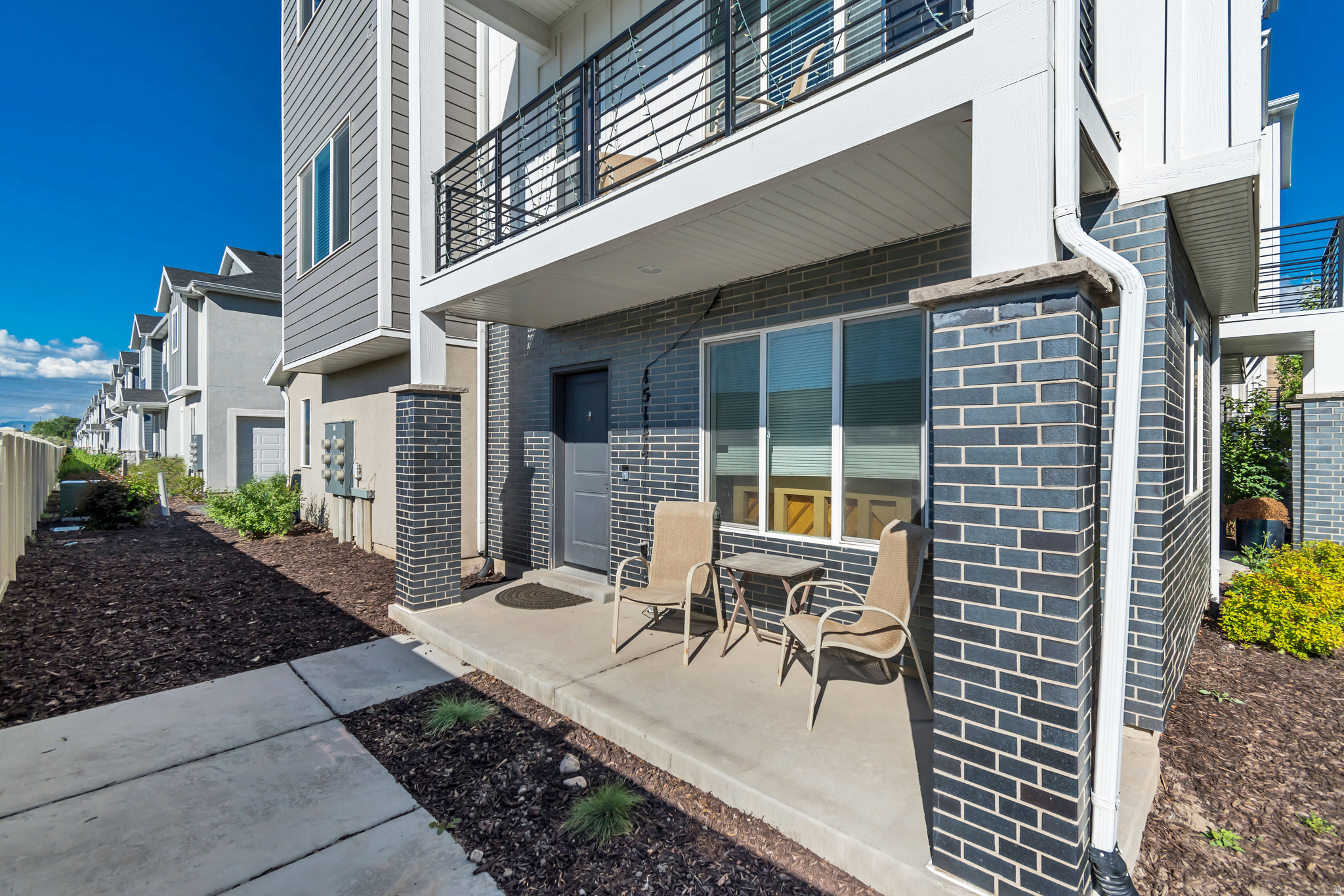 This spacious end-row townhome offers 2 primary suites, 2.5 bathrooms, and a flexible layout designed for comfortable living and easy entertaining. The bright, open kitchen features quartz countertops, while new flooring on the main level adds an updated contemporary feel throughout the home. Both upstairs bedrooms include private en suite bathrooms, creating the perfect setup for guests, roommates, or dual primary living. Need additional space? The lower level offers the potential for a 3rd bedroom, office, gym, or flex space to fit your lifestyle. Enjoy the added privacy and natural light that comes with an end-unit location, plus the convenience of an attached 2-car garage with extra storage space. Located within walking distance of a large new park. This home combines modern comfort with exciting future neighborhood amenities. A fantastic opportunity at an incredible value! Schedule your private showing today!