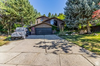 Absolutely stunning and updated North Ogden home! Upon entry, you'll be captivated by the open entry way and spacious Living room that features vaulted ceilings with Wood Beam details and Ogden Valley Views from your front windows. The updated kitchen, complete with granite countertops, 2 refrigerators and gas range, offers plenty of room to move around in and is perfect for entertaining that transitions right into the spacious dining room with access to 1 of many outside patio areas that are perfect for an evening BBQ or enjoying the privacy the backyard offers on all sides. Back inside the home, on the main level, there is also a large bedroom and full updated bathroom, in addition to the updated laundry area and generously sized kitchen pantry. The large owner's suite is situated upstairs with ensuite bathroom, large master closet, and private walkout to a secluded patio. Also, 1 additional generously sized bedroom and another updated bathroom. Downstairs, the basement offers 3 additional bedrooms - 1 of which could be used as a 2nd living space, if desired - and a 3/4 bathroom. This home boasts a two-car garage, a private backyard, mature fruit trees and multiple outdoor entertainment spaces and your very own, creek side oasis with stream and natural waterfall. The home is ideally located on a cul-de-sac/dead-end road with personal access to a walking / biking path on the hillside from the back yard. Don't miss out on everything this home has to offer. Schedule your private showing today and make this dream home yours! Square footage figures are provided as a courtesy estimate only and were obtained from the county records. Buyers are advised to obtain an independent measurement and verify all information provided.