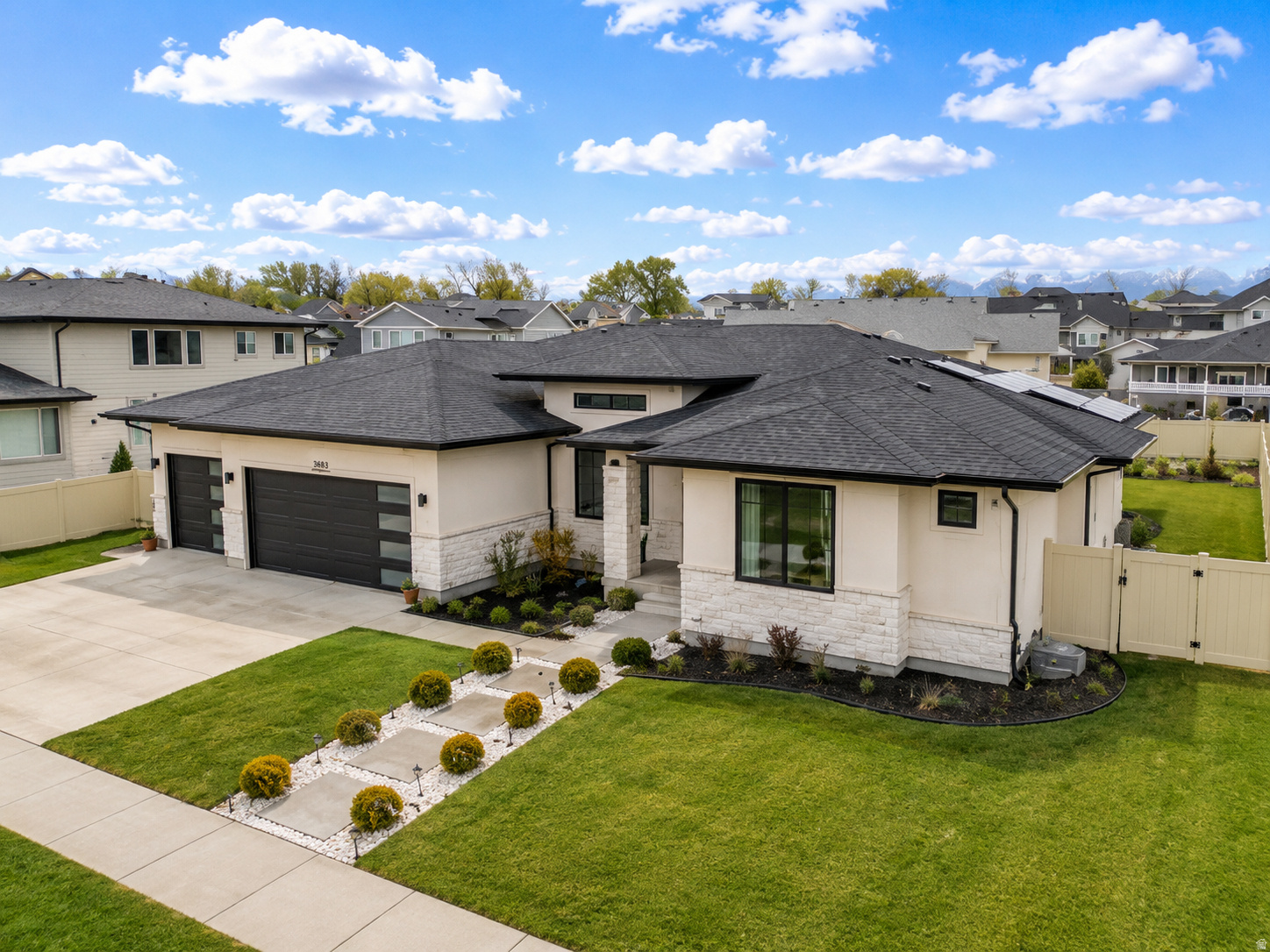 Welcome to this exquisite 7 bedroom, 5 bathroom rambler in Draper, Utah. This home combines luxury living with energy efficiency, featuring high-end finishes, solar panels with a TESLA BACKUP BATERY SYSTEM, and an ideal location near a variety of amenities and just minutes from I-15. The spacious main floor offers an open layout with expansive windows that flood the home with natural light. The chef's kitchen is complete with an oversized island, custom cabinetry, and a large walk-in pantry. The main floor also includes three generously sized bedrooms, plus a stunning, private master suite that provides direct access to a covered patio perfect for morning coffee or evening relaxation. The fully finished walkout basement is a standout feature of this home. It includes a separate kitchen, living area, bathroom, and two bedrooms, all of which can be easily isolated from the rest of the home, making it an ideal space for multi-generational living or potential rental income. The second portion of the basement has been designed as an entertainment haven, featuring a spacious living area, a theater room, a second bathroom, another bedroom, and ample storage space. Enjoy the quick access to the Jordan River Trail system. This must-see home has everything you need for modern living. CO-OWNERSHIP opportunity available!