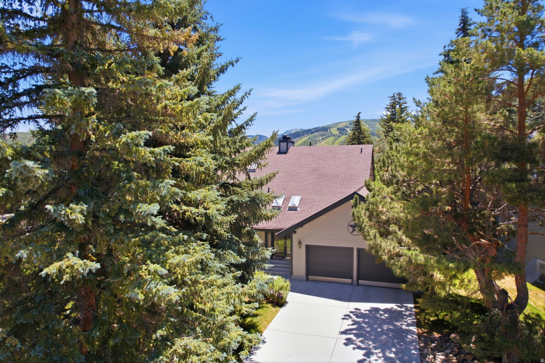 In a town built on the discovery of rare value in these mountains, 163 Webster Court is the real estate equivalent of a genuine find. Constructed in 1981 among Park City's first luxury homes, this Thaynes Canyon original has anchored one of Utah's earliest and most enduring residential communities for more than four decades. Steps from Hotel Park City and the Park City Municipal Golf Course, directly on Park City's free bus route to the Park City Mountain Resort and Historic Main Street, this lovely home boasts a floor plan that balances grand entertaining with genuine everyday livability. The primary suite with a spa like ensuite is on the main floor. The primary suite has a gas fireplace for a cozy retreat on a chilly day. A full 2004 remodel -- architectural plans on file -- brought contemporary refinement to the kitchen: oversized prep island, generous cabinetry, and an open flow designed for both cooking and entertaining. The living room features a concealed wet bar and opens to its own private deck with ski resort views. A second covered heated deck off the kitchen extends living space outdoors in every season. Three wood-burning fireplaces with original Art Deco mantles appear on every level - each one an authentic period detail impossible to replicate in new construction. Upstairs two bedrooms -- both with ensuites -- surround a sitting area with dry bar and a loft ideal for a home office or additional sleeping......and a dry sauna. The lower level is a destination in itself: polished concrete floors, a family room primed for a home theater, game room, wet bar, large sauna with dedicated bath, custom built-in library bedroom, and laundry. Three distinct configurations across all three levels tell the story of a home designed for effortless entertaining. Exceptional storage throughout. 2-car garage. Home offered unfurnished. Estate Sale on premises August 7 & 8 -prospective buyers are welcome to attend and purchase furnishings directly. No private showings during the sale.