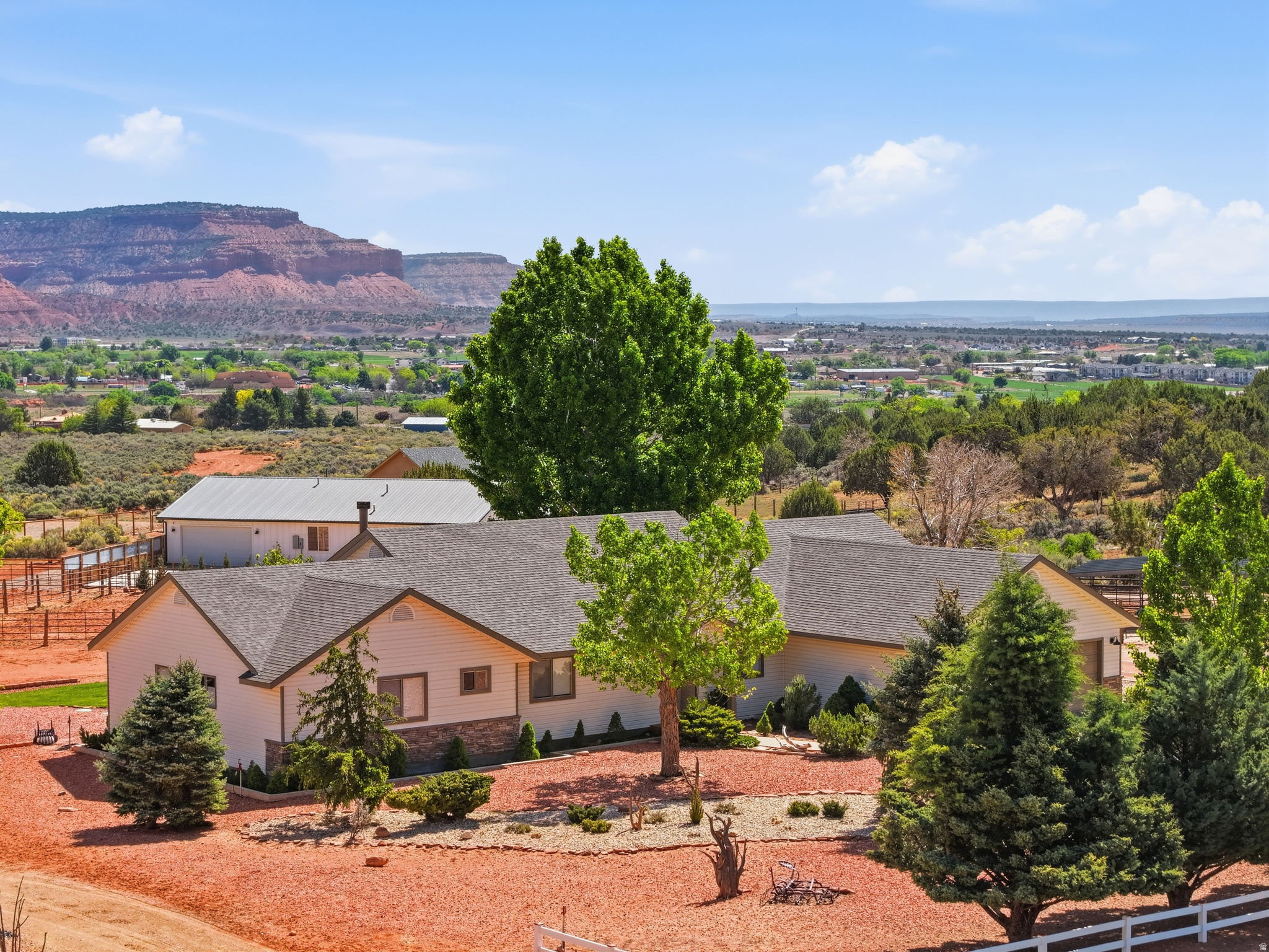 Welcome to this beautifully remodeled ranch-style retreat, thoughtfully reimagined to blend timeless charm with modern luxury. Set on 1.46 acres in a highly sought-after and established neighborhood, this exceptional property captures breathtaking red rock views from nearly every window. An inviting entryway welcomes you inside, where a private office with custom built-in bookcases offers the perfect space for working from home or quiet reflection. Vaulted ceilings draw you into the expansive great room, creating an open, light-filled atmosphere ideal for both everyday living and effortless entertaining. At the heart of the home, the brand-new chef's kitchen is designed to impress. Showcasing stunning granite countertops, a gas cooktop range, an oversized island with seating, a dedicated coffee bar, and a wine fridge, this space is perfectly equipped for gatherings of any size. A rustic beam accent and striking rock wood-burning fireplace anchor the living area, adding warmth and character-an inviting setting for cozy evenings. With five generously sized bedrooms, three well-appointed bathrooms, and an additional den ideal for a media room or secondary living space, the home offers exceptional flexibility to suit a variety of lifestyles. Short-term rentals are allowed, presenting a compelling investment opportunity as well. Outdoors features include mature trees, horse corrals, and thoughtfully designed landscaping enhance the natural beauty of the grounds. Unwind on the covered patio and take in the peaceful surroundings and stunning red rock vistas. Furnishings are available for purchase under a separate bill of sale, offering the potential for a seamless, turn-key transition. Buyer to verify.