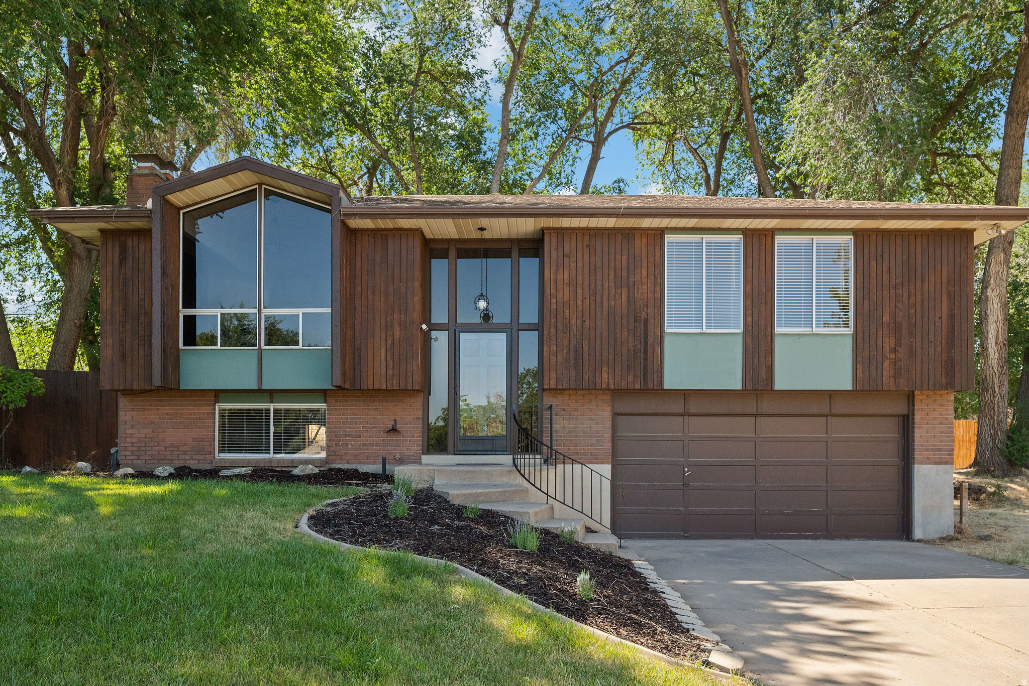 Welcome home to this beautifully updated North Salt Lake rambler, ideally located on a quiet cul-de-sac just minutes from downtown Salt Lake City and the Airport. Offering 3 bedrooms, 2 bathrooms, and the potential to easily add a 4th bedroom in the spacious family room, this home combines modern updates with timeless character. Inside, you'll find fresh paint, new carpet, luxury vinyl plank flooring, and stunning quartz countertops, while preserving the architectural charm buyers love-floor-to-ceiling windows that flood the home with natural light, classic brick fireplaces, and warm wood accent walls that create an inviting atmosphere. Situated on a large, mature lot with established trees, the backyard offers privacy, shade, and room to relax, garden, or entertain. The quiet cul-de-sac location provides a peaceful neighborhood setting with minimal traffic. One of North Salt Lake's greatest advantages is its unbeatable location. Enjoy quick access to downtown Salt Lake City, the airport, major employment centers, and I-15 while still enjoying a more residential, community-oriented lifestyle. Homeowners love the area's proximity to hiking and biking trails, golf courses, parks, and outdoor recreation, including nearby Tunnel Springs Park, Wild Rose Trailhead Park, and Legacy Park. NSL is known for offering the perfect balance of convenience, outdoor access, and a quieter atmosphere just outside the city. Whether you're looking for a move-in-ready home, space to grow, or a location that makes commuting and travel effortless, this property delivers exceptional value in one of Davis County's most desirable communities.