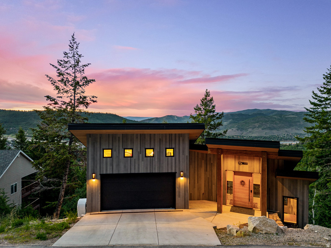 Set among the trees in Summit Park, 430 Matterhorn Drive is a warm, modern mountain retreat with striking architecture, expansive windows, and beautiful sunrise views. This 4-bedroom, 3-bath home offers 3,046 square feet on 0.66 acres, with two thoughtfully-designed levels that make the most of its alpine setting.    The main level centers around an open great room with soaring ceilings, oversized windows, and a seamless connection between the living, dining, and kitchen areas. The kitchen features warm walnut cabinetry, granite countertops, a large island with seating for four, and a built-in dining banquette. Custom walnut bookshelves, generous gathering space, and access to the outdoor patio create an inviting layout for everyday living and entertaining, all framed by views of the surrounding trees and mountains. A bedroom, full bathroom, and additional bedroom/office complete the main level.    Downstairs, the lower level offers a spacious family room, walk-out patio access, and a premium HUUM sauna with a Himalayan salt wall. Whether returning from nearby trails or a day on the slopes, the sauna provides a relaxing place to unwind and recover. This level also includes a bedroom with an ensuite, an additional bedroom currently used as a gym, a full bathroom, and laundry room, creating flexibility for guests, work, fitness, or additional living space.    With a heated driveway, extra-deep garage with loft, and incredible access to nearby trails, this home is designed for year-round mountain living. Two trailheads are just a short distance away, making it easy to hike, bike, or backcountry ski right from home.    Summit Park offers a peaceful, forested setting near Parley's Summit with quick access to Park City Mountain, Deer Valley, Woodward Park City, hiking and biking trails, Kimball Junction, dining, shopping, and everyday conveniences. With I-80 nearby, it is easy to move between Park City and the Salt Lake Valley, creating an ideal balance of recreation, comfort, and accessibility.
