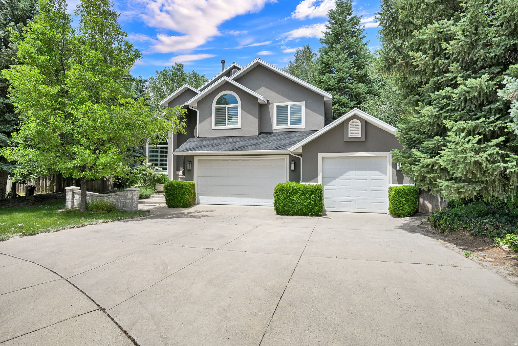 Tucked away on a quiet cul-de-sac in the desirable Mill Hollow neighborhood, this beautifully updated Cottonwood Heights home offers the perfect blend of comfort, style, and location. Surrounded by mature trees and mountain views, you'll enjoy a peaceful setting just minutes from everything that makes this area so special. Inside, the thoughtfully designed floor plan is filled with natural light, vaulted ceilings, hardwood floors, and beautifully updated living spaces. The remodeled kitchen is the heart of the home, featuring quartz countertops, stainless steel appliances, abundant pantry storage, and a spacious center island perfect for everyday living and effortless entertaining. French doors open to a private deck overlooking mature landscaping, creating an inviting outdoor space for morning coffee, summer dinners, or relaxing after a day in the mountains. The spacious primary suite offers a beautifully updated bathroom with a separate tub and shower, a walk-in closet, and a peaceful retreat at the end of the day. With five bedrooms and multiple living spaces, this home offers flexibility for guests, a home office, hobbies, or room to grow. Additional features include a spacious three-car garage with extra width and length, plantation shutters, updated lighting, a smart thermostat, and generous storage throughout. Located just minutes from Big and Little Cottonwood Canyons, world-class skiing, hiking and biking trails, parks, shopping, dining, Park City, downtown Salt Lake City, Salt Lake City International Airport, and within the highly regarded Brighton High School boundary, this home offers an exceptional opportunity to enjoy one of Cottonwood Heights' most desirable neighborhoods.