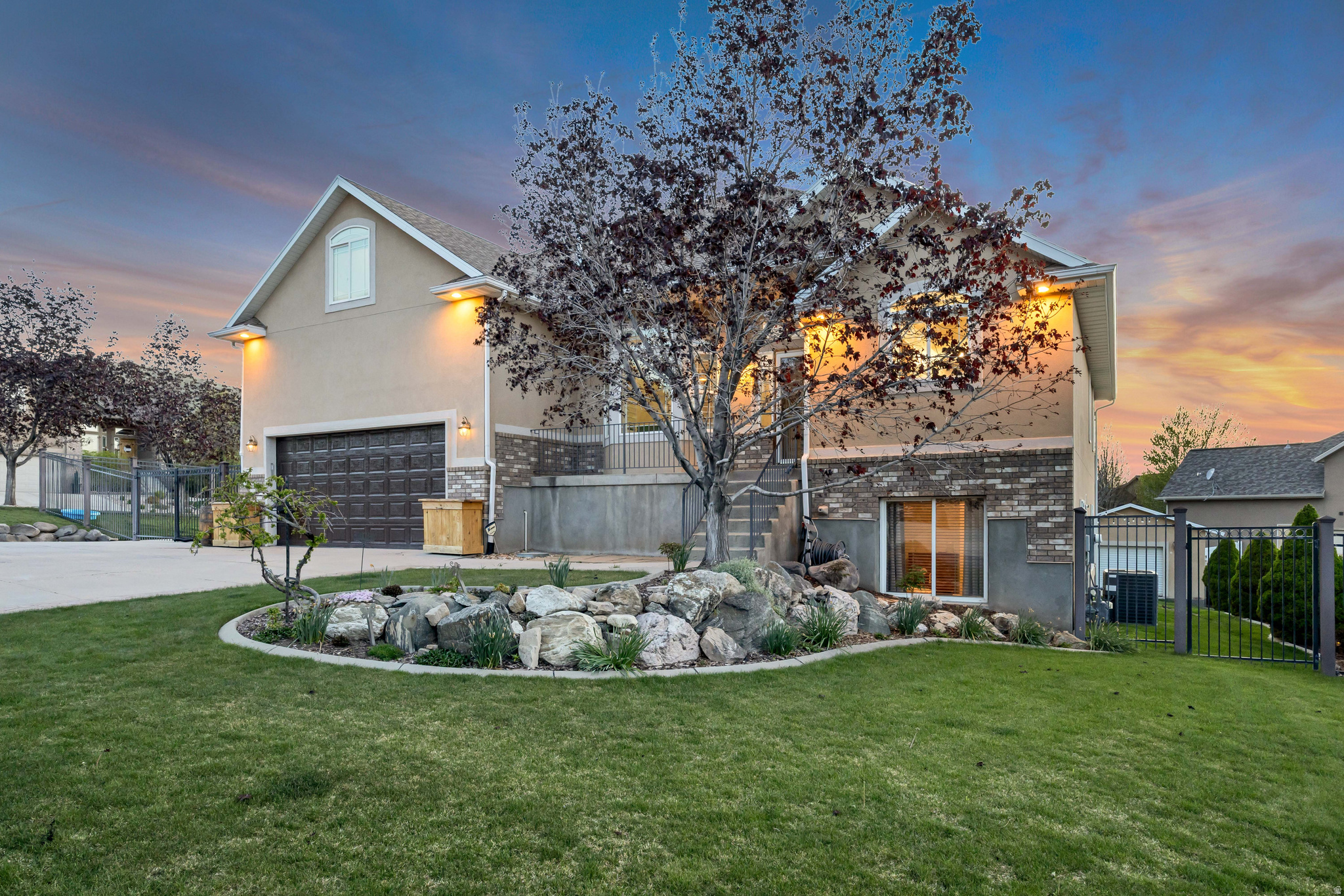 Welcome home to your Skyline Sanctuary! Set up above the city in the highly desirable Skyline neighborhood, this incredible home offers breathtaking, 360 degree views of the mountains and the Great Salt Lake. Specially designed to comfortably host large or multi generational families, this property perfectly balances ample spaces for togetherness with private retreats for everyone. The expansive main floor boasts vaulted ceilings and large windows that flood the open concept family room and kitchen with glorious natural light. The kitchen features granite countertops, a gas range, and an included LG refrigerator. The main floor laundry is tucked discreetly to keep daily chores effortless. There is a convenient guest half bath and an intimate front room with quiet, elegant space perfect for your piano, formal furniture, or cozy visits with close friends. The main floor primary suite is a true retreat with soaring ceilings, his and her closets, extra room for a sitting area or oversized furniture, leading into an oversized master bathroom. Plus private door access directly to the back deck. Upstairs offers three spacious bedrooms, each boasting its own oversized closet plus a full central bathroom and dual hallway storage closets. Additionally the wide open landing is a bonus area easily utilized as a homework station, computer nook, or playroom. The private daylight walk out basement features its own entrance, but is also accessible from the main level. It is designed with independent living in mind, making it a perfect mother in law apartment or guest suite. It boasts a large comfortable bedroom, full bathroom, second fully equipped kitchen (refrigerator and microwave included), a built in open concept office, crafting, or sewing studio; and there are also large dedicated storage areas, including a cold storage room with built in shelving. Outside the property matches the exceptional value found within the home, where upgraded wrought iron fencing surrounds a large yard complete with mature landscaping, fully irrigated garden box, a dedicated cement pad with a built in gas fire pit, and the easily accessible RV pad with a 50 amp electrical hookup. The back deck is the perfect spot for morning coffee or hosting unforgettable sunset parties overlooking the lake with an additional gas line making outdoor grilling seamless. There is unmatched storage and toy parking with an extra deep garage featuring a built in storage mezzanine, and a separate, custom outbuilding built to perfectly match the home ideal for a workshop, adventure vehicle parking, or ultimate storage. There is so much more to this home than meets the eye, surrounded by fantastic neighbors who respect your privacy. It truly offers something for everyone  Come feel the warmth of this estate yourself and schedule your tour today before someone else claims your dream! All information herein is deemed reliable but is not guaranteed. Buyer is responsible to verify all listing information, including square feet/ acreage, to buyer's own satisfaction.