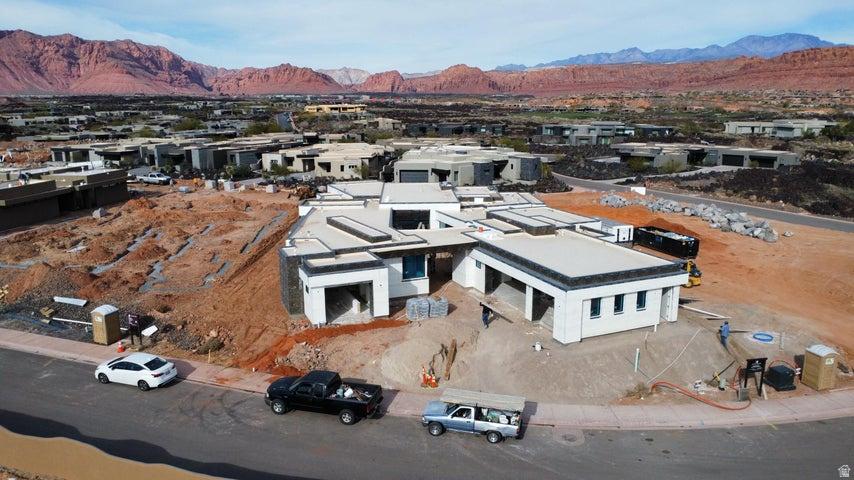 Welcome to this Split Rock custom build that is an exceptional residence in the prestigious Entrada community, offering 4,926 square feet of refined living space. With 5 bedrooms, 5.5 bathrooms, and a spacious 4-car garage, this home blends modern elegance with timeless comfort. Walls of glass frame the extraordinary red rock and mountain vistas, creating a seamless connection between indoor living and the breathtaking natural surroundings. The open-concept design features expansive living areas, a chef's kitchen with top-tier finishes, and thoughtfully designed spaces for both entertaining and relaxation.  Each bedroom offers its own private ensuite, ensuring comfort and privacy for family and guests alike. The primary suite is a retreat of its own, with stunning views and a spa-inspired bathroom An incredible outdoor living space extends the home's lifestyle to the desert landscapeperfect for relaxing, entertaining, or dining beneath Entrada's signature sunsets. Whether gathering with friends or savoring quiet moments, this home captures the very best of luxury living.