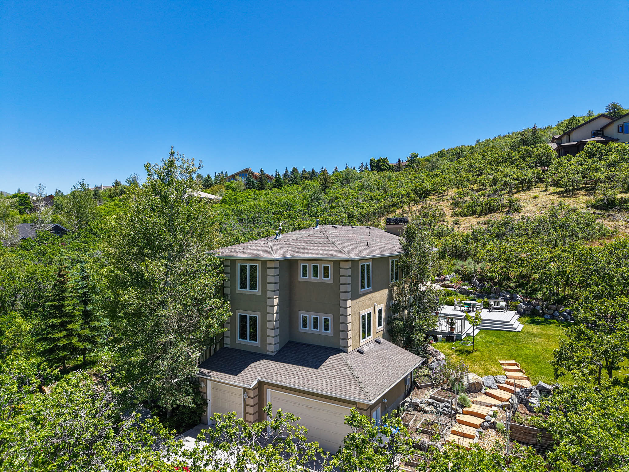 There is a reason people escape to the mountains. The quiet. The fresh air. The reminder that life is meaningful. Our days are often spent solving problems, making decisions, and carrying responsibilities. At day's end, this gracious mountain retreat invites you to slow down, breathe deeply, and reconnect with what matters most. Nestled in the beauty of Emigration Canyon, this lovely and authentic residence offers a rare opportunity to enjoy mountain living without sacrificing convenience. Just minutes from the University of Utah, University Hospital, Research Park, and downtown Salt Lake City, it provides a peaceful refuge for those who value both intellectual pursuits and a deep connection to nature. Thoughtfully positioned to embrace its remarkable surroundings, numerous windows frame breathtaking views from nearly every room, capturing canyon vistas, surrounding mountains, and sparkling valley lights below. The expansive, bright and well laid-out kitchen flows seemlessly into the inviting family room and a charming, intimate eating area, where many meaningful conversations can be had.  A dedicated study with a fireplace offers an inspiring setting for reading, writing, research, or quiet reflection. The spacious primary suite is a private sanctuary featuring a cozy fireplace, sitting area, private balcony, dual walk-in closets, and an exceptionally generous bath. Outdoors, there are expansive Trex decks off both the dining room and family room providing the perfect setting for morning coffee, evening sunsets, or simply listening to the rustle of leaves in the mountain breeze.  Extensive professional landscaping features stone pathways, rock walls, and garden spaces that blend beautifully with native wildflowers and perennials. Throughout the home, thoughtful design, abundant natural light, and a strong connection to the outdoors create an atmosphere that is both welcoming and restorative. While ready for some fresh updates, the home has been meticulously maintained and is wonderfully livable today; clean, comfortable, and welcoming.  Close to the pursuits that inspire you. Far from the noise that distracts you.  The rarest luxury isn't extravagance. It's tranquility.