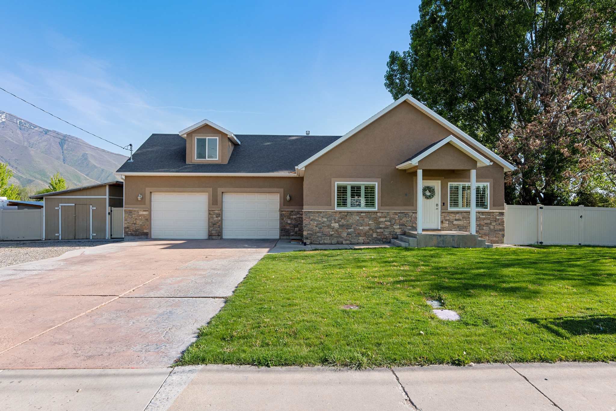 Don't let the curb appeal fool you, this home is bigger than it looks! Situated on a spacious .34-acre lot, the property features a huge concrete pad with plenty of room for extra parking, RVs & trailers. Fresh paint and new carpet throughout give this beautiful home a fresh, move-in-ready feel. Basement is 100% finished offering a family room with a built in fireplace. The soacious master bedroom feautures his-and-hers walk-in closets.  Just minutes from Mapleton school and parks. Square footage figures are provided as a courtesy estimate only and were obtained from county records.  Buyer is advised to obtain an independent measurement.