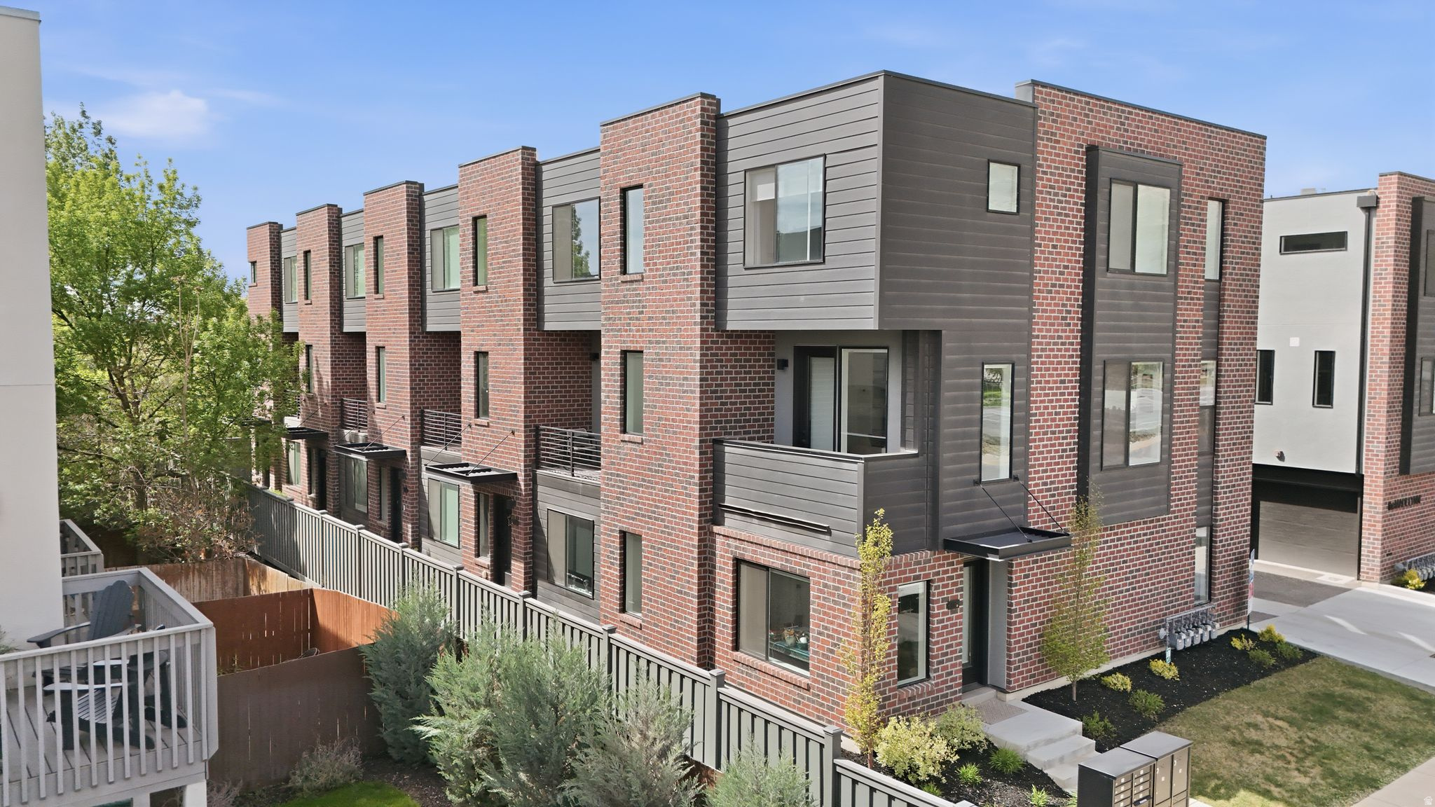 Upgrades throughout include a Custom, Hand Crafted, Venetian Plaster accent wall, Tiffany-style overhead lighting, an electric vehicle outlet, and built-in garage storage racks. This modern, quiet end-unit townhome offers rare flexibility and livability just minutes from downtown. Oversized windows fill the home with natural light, while the main living level flows effortlessly for both everyday living and entertaining, complete with a private balcony for a quiet escape. Upstairs, two spacious bedrooms each feature en-suite baths and walk-in closets, creating a comfortable separation of space. A generous ground level, flex room adds versatility-ideal for a home office, gym, media space, or easily a third bedroom. The two-car garage is a standout feature in the community, offering added convenience and functionality. Enjoy easy walkability to a diverse mix of local restaurants, bars, coffee shops, and the Marmalade Public Library, along with quick access to trails, the airport, and all that Salt Lake City has to offer