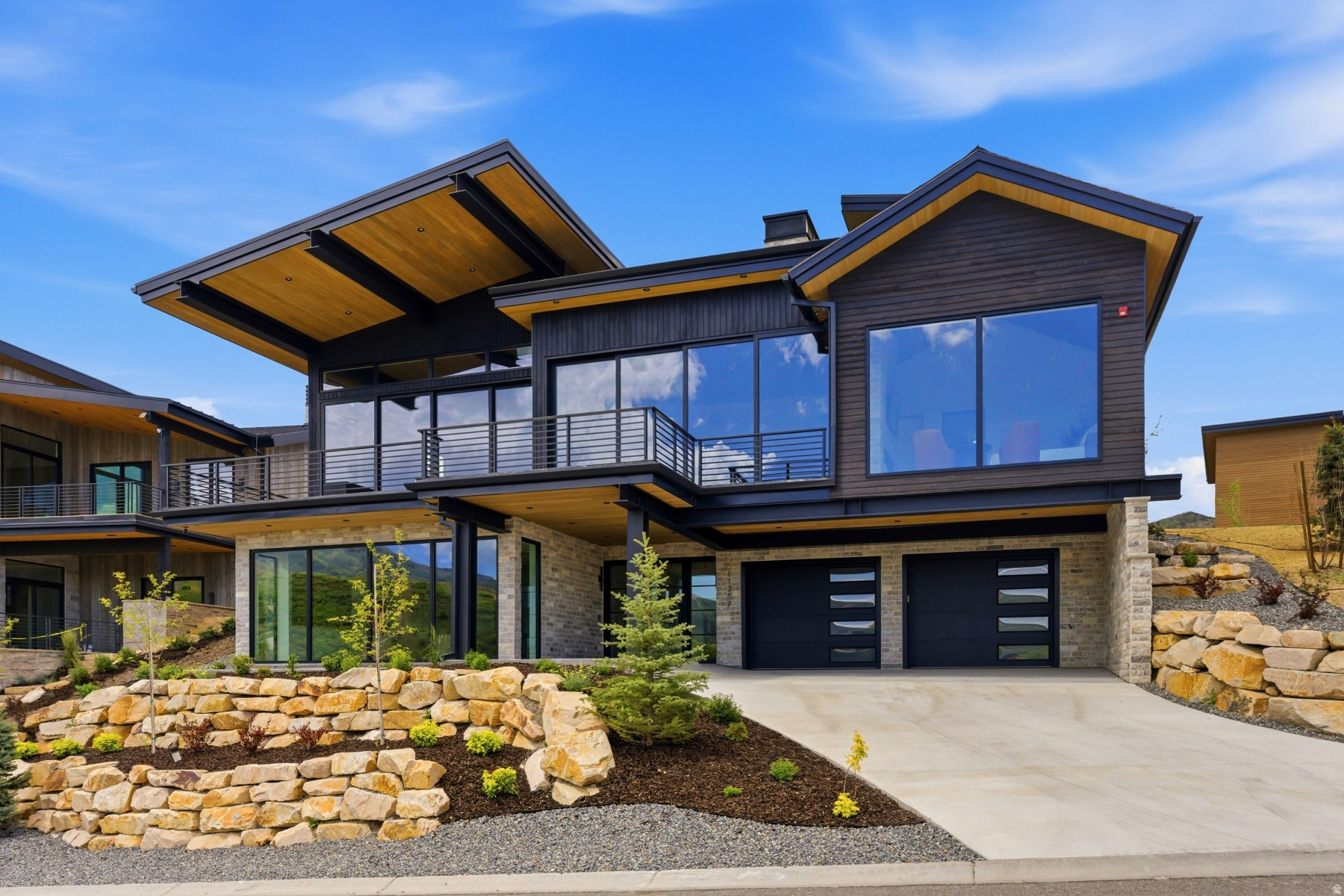 This new home in the coveted SkyRidge Resort Community offers one of the most dramatic view corridors in Deer Valley East, where expansive ski slope vistas fill nearly every room and the Jordanelle Reservoir sparkles beyond. The slopes are so close it feels like ski-in/ski-out living, creating an immersive mountain experience unlike anything else in the area. At the heart of the home is a breathtaking 1,700-square-foot great room featuring a spectacular floating fireplace and an open-concept chef's kitchen designed for entertaining on a grand scale. A 45-foot wall of glass with soaring 11-foot pocket/sliding doors captures the stunning Deer Valley East ski runs and reservoir views while seamlessly connecting indoor and outdoor living spaces.Extraordinary craftsmanship is showcased throughout with imported Italian cabinetry, custom Warren Christopher herringbone and wide-plank hardwood floors, rich wood-clad walls and ceilings, and striking wood-and-steel architectural beams. Every finish, fixture, and lighting detail has been carefully selected to create a warm yet sophisticated mountain-modern retreat. The entertainment level features a spacious game room and private movie theater with a 100-inch screen, while a flexible bonus room off the garage serves perfectly as a gym, bunk room, office, or additional guest space. The luxurious primary suite is complemented by an oversized walk-in closet that is truly a showpiece.Outside, a private backyard offers the perfect setting to unwind after a day on the slopes, complete with a putting green and inviting outdoor gathering spaces. Offered fully furnished, this turnkey residence delivers designer-perfect interiors, unforgettable views, and the ultimate Deer Valley lifestyle. SkyRidge amenities include a championship golf course, two-tier driving range, private clubhouse with pool and fitness facilities, equestrian center, dining, and private shuttle access to Deer Valley East Village.This is a limited opportunity to secure a premier legacy property within one of North America's most dynamic luxury resort markets where elevated design, effortless access, and year-round alpine lifestyle converge.