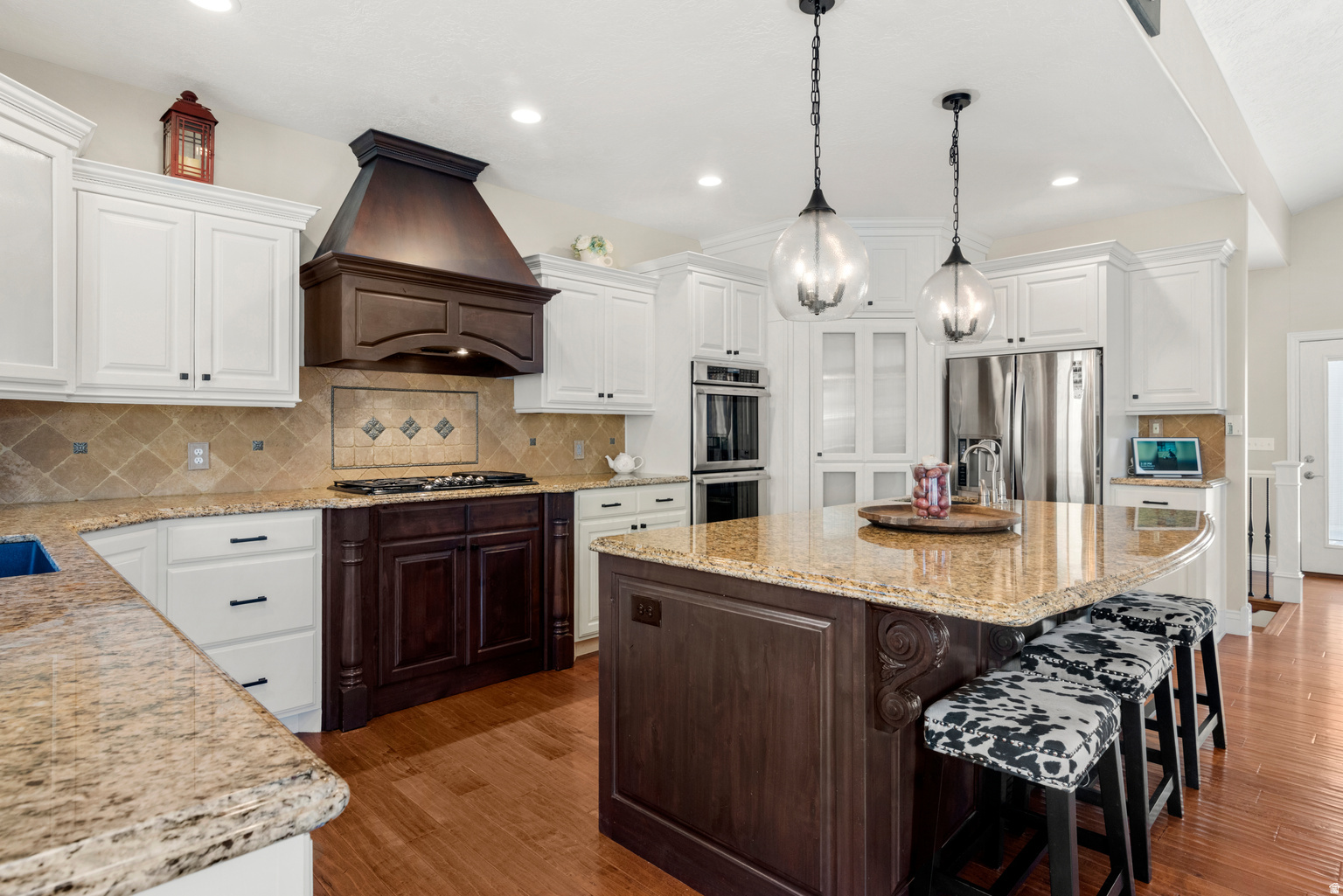 Secured by a private gated entrance on 5 flat, pristine acres with a dramatic mountain backdrop, this magnificent 6,251 sq. ft. luxury estate seamlessly pairs high-end living with professional-grade equestrian facilities. The bright and airy main floor centers around a premium gourmet kitchen with three-zone radiant heated floors that flows into a cozy fire lit family room, alongside a private primary suite boasting panoramic Wasatch views. Designed for ultimate relaxation, the massive 100% finished walkout basement features a pre-wired media room, a home gym, and direct access to a covered patio and luxury spa. Outside, the world-class horse setup is fully turnkey, offering an 1,800+ sq. ft. 4-stall barn with a designer chandelier and outdoor runs, a 60' round pen, and a massive 190' x 160' riding arena, all with ample space left to further customize your dream footprint.