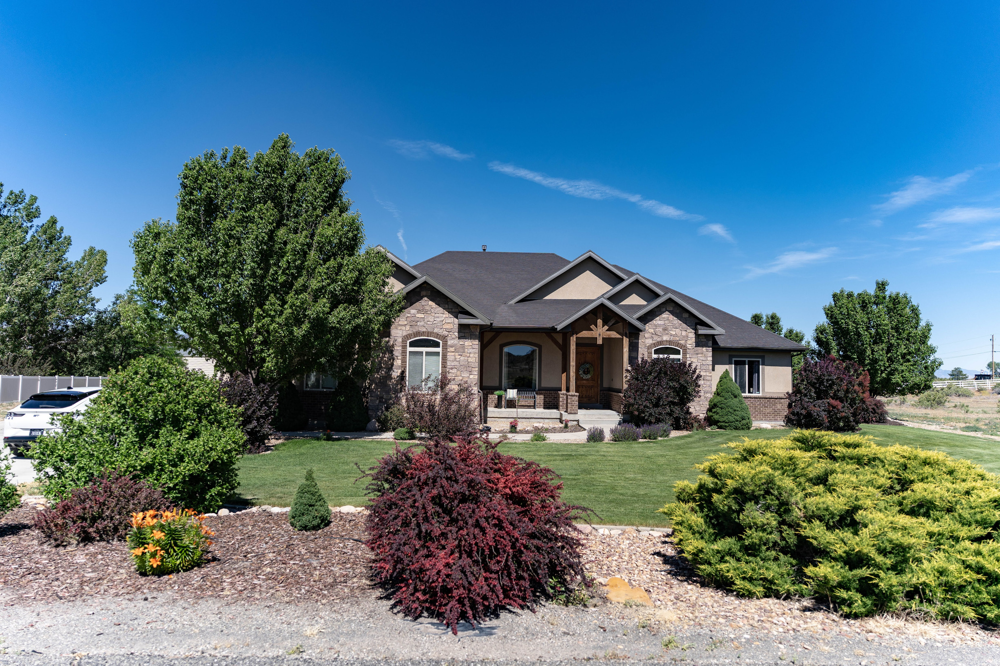 Welcome to your dream home in the highly sought-after Gordon Creek area of Price! Custom built by premier builder Kevin Callahan, this exceptional 5-bedroom, 4-bath residence combines quality craftsmanship, thoughtful design, and outstanding living spaces both inside and out.  At the heart of the home is a stunning chef's kitchen featuring abundant cabinetry and counter space, a large center island, dual ovens, and an open-concept layout that seamlessly connects to the dining area and spacious family room-perfect for entertaining and everyday living. A dedicated den provides flexible space for a home office, library, or study.  The luxurious primary suite offers a large walk-in closet and a spa-like ensuite bath complete with dual sinks, a relaxing soaker tub, and an oversized walk-in shower. Main-level laundry adds convenience, while generous storage space throughout the home ensures room for everything.  The thoughtful layout of the basement expands your living options with an impressive family room ideal for a theater room, game room, fitness area, or gathering space. A convenient kitchenette featuring a sink, microwave, and refrigerator makes hosting guests or entertaining effortless.  Step outside and enjoy beautifully landscaped grounds designed with pride and attention to detail. The backyard is an entertainer's paradise, featuring an above-ground pool with a custom-built deck and a large covered patio that's perfect for summer barbecues, evening relaxation, and outdoor gatherings. With ample space between neighboring properties, you'll appreciate the privacy and peaceful setting.  Additional features include a built-in 3-car garage with an electric vehicle charging hookup, central air conditioning, abundant storage, and the quality construction that comes from one of the area's most respected builders. The home is also equipped with Govee permanent outdoor programmable lighting, allowing you to customize colors and displays year-round for holidays, special occasions, or everyday curb appeal.  This is a rare opportunity to own a meticulously maintained custom home in one of Price's most desirable neighborhoods. Schedule your private showing today.