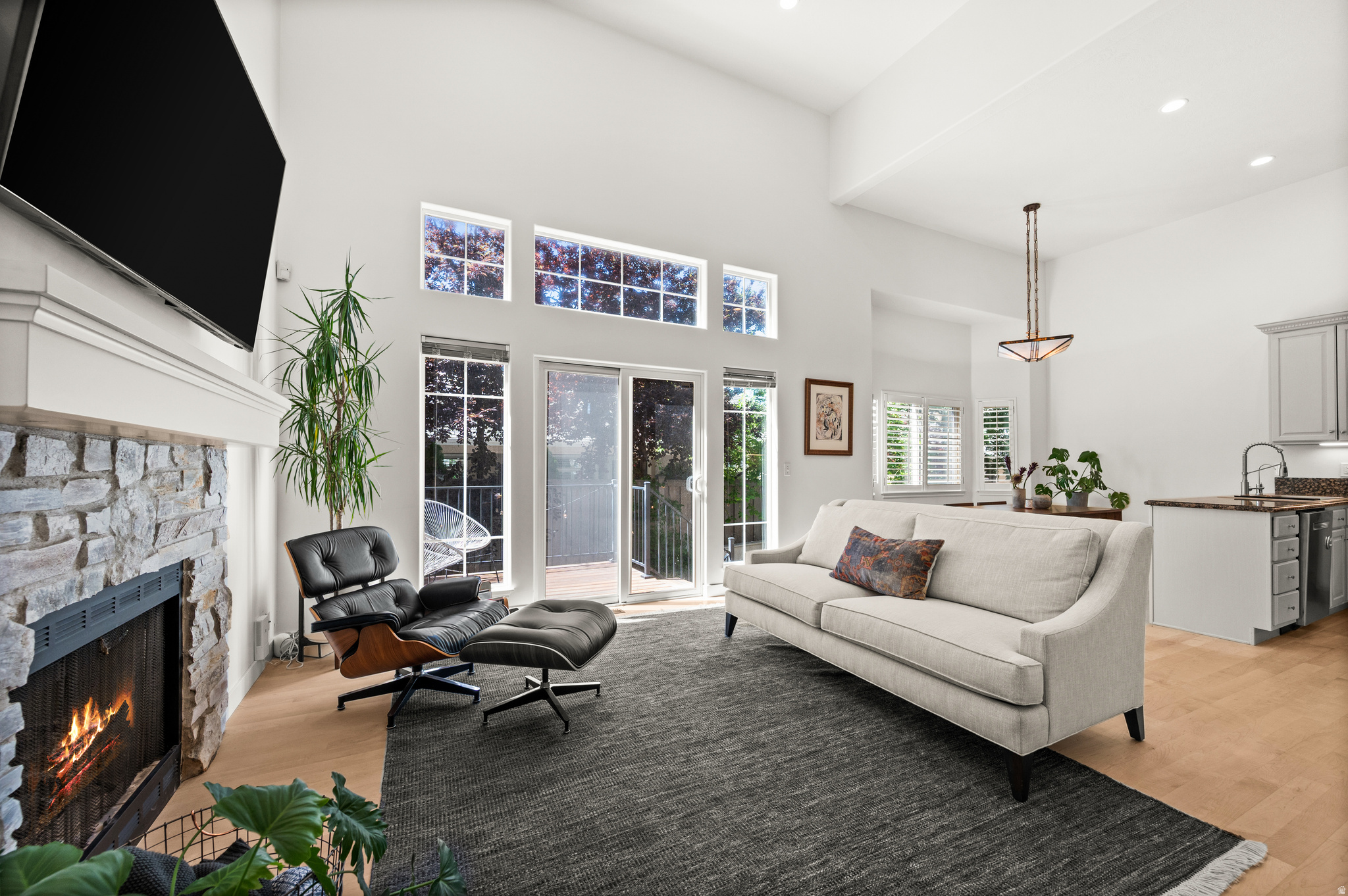 If convenience, comfort, and location top your wish list, look no further! Ideally situated just steps from the vibrant Holladay Center, this beautifully maintained townhouse offers an unbeatable walkable lifestyle. Stroll to your favorite coffee shop, grocery store, restaurants, gym, boutiques, art galleries, library, city hall, post office and neighborhood park featuring pickleball courts, kids playground and a skate park - all without needing your car. Inside, soaring 16-foot ceilings create an airy, inviting and light filled great room, dining room and kitchen, while thoughtful updates provide peace of mind and modern comfort. Enjoy gorgeous new maple hardwood floors (2024), a new HVAC system and hot water heater (2024), plus new refrigerator, microwave, washer, and dryer (2024). Relax year-round in your private hot tub or enjoy the charming, low-maintenance yard with just enough space for gardening or your furry friend. Additional highlights include a gated community, attached 2-car garage, and convenient freeway access. Perfectly positioned for both work and play, this home is approximately 15 minutes to downtown Salt Lake City, the University of Utah campus, U of U Medical Center, and Salt Lake International Airport. Outdoor enthusiasts will love being within 30 minutes of five world-class ski resorts. Exceptional value in one of the area's most desirable locations!  Square footage figures are provided as a courtesy estimate only.  Buyer is advised to obtain an independent measurement.