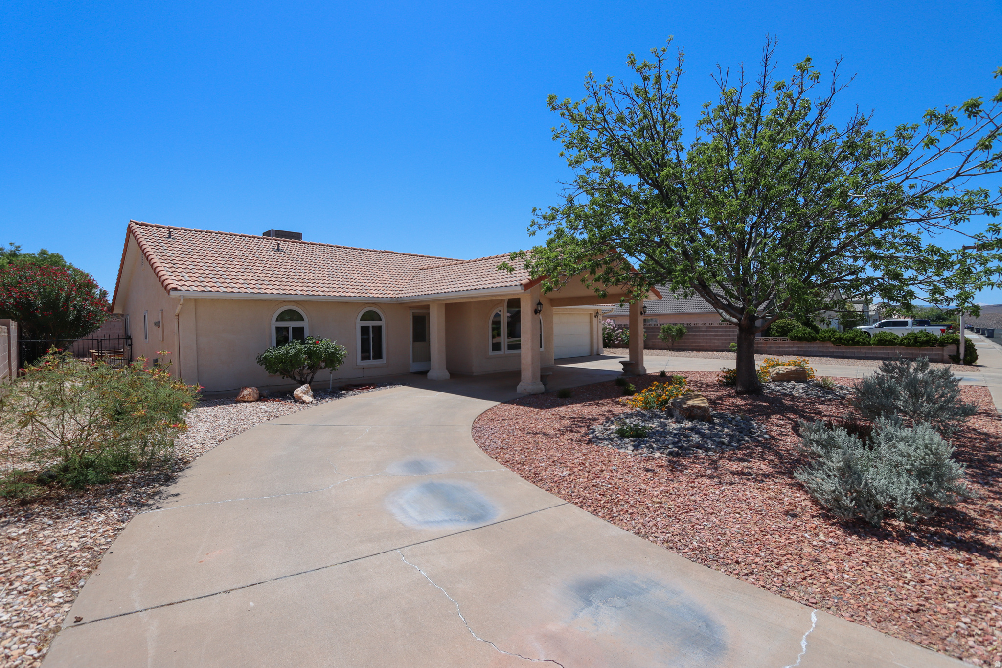 Elegant home with a new chef's kitchen, new flooring, and beautiful, professionally landscaped yard. Enjoyable views to Ivins and beyond. This home blends seamlessly into a bright and happy neighborhood, and it's full of character. Touches like arched windows, a plant ledge, quartz countertops, garden boxes, a shady covered patio, a grapevine-clad fence, xeriscaped front yard, courtyard driveway, pomegranate tree, lush grass, and a garage workbench make this home truly special. Home has been partially remodeled, and it's ready for new owners. Kitchen was updated and new flooring was installed in 2020. New windows were installed in 2021. Home is within walking distance of great schools. Wonderful, lovable home in an exquisite location. Square footage figure is provided as a courtesy estimate only. Buyer is advised to verify.