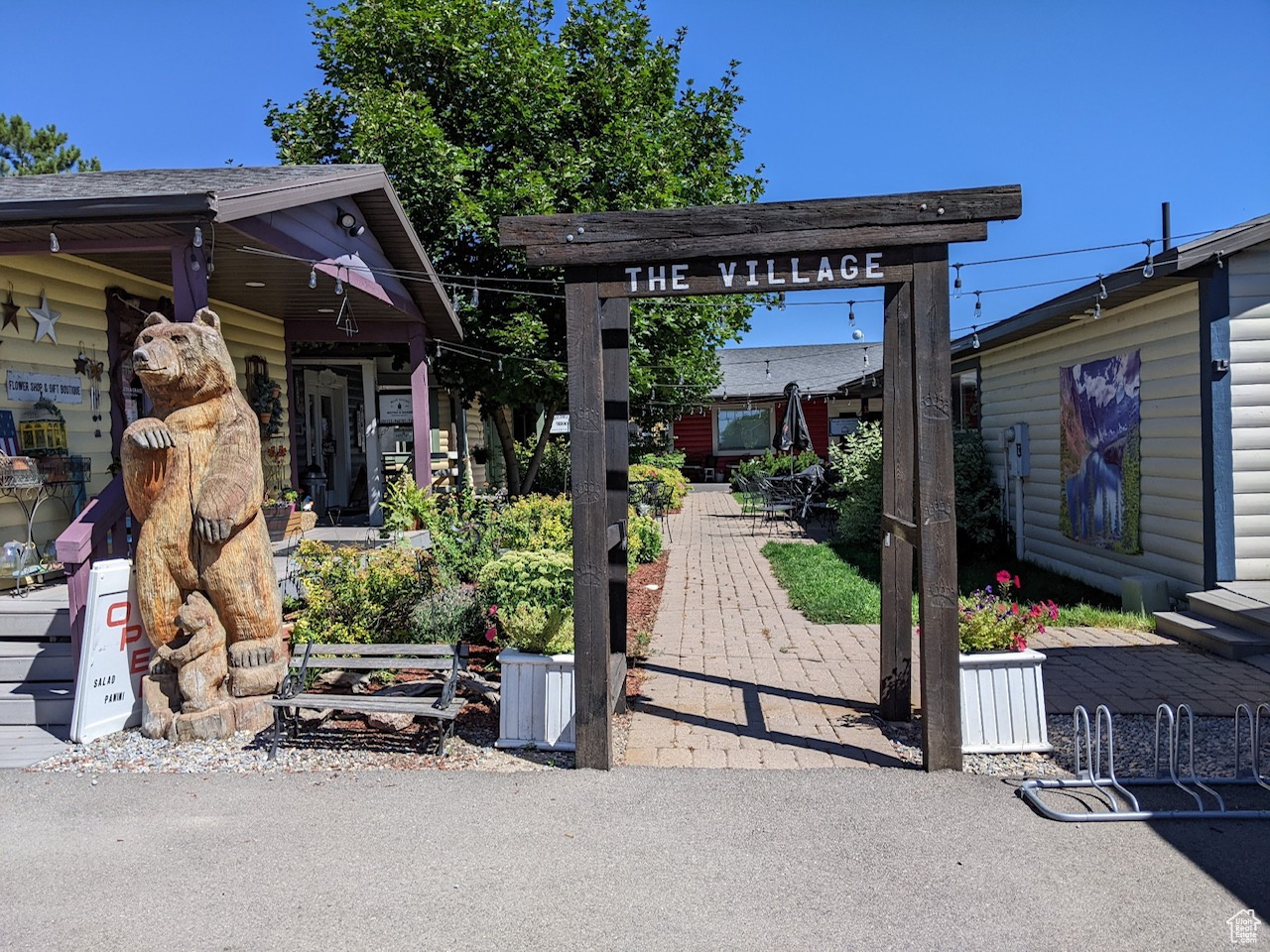 THE VILLAGE! A darling shopping center in the hub of Garden City at beautiful Bear Lake! A prime location with good visibility, accessibility, and traffic attracts customers. Fully rented commercial property with 7 colorful buildings consisting of 10 units with covered decks, surrounding a peaceful courtyard setting with mature landscaping, seating, arched entry cobblestone walkway, and two restrooms. Popular Bear Lake recreation area, with huge number of year-round tourists, especially in summer. Paved parking on the east. Shared parking on the south.  Great potential for appreciation in the growing Bear Lake Valley!  Reduced price now $167-per square foot!  Ask about Seller Financing.