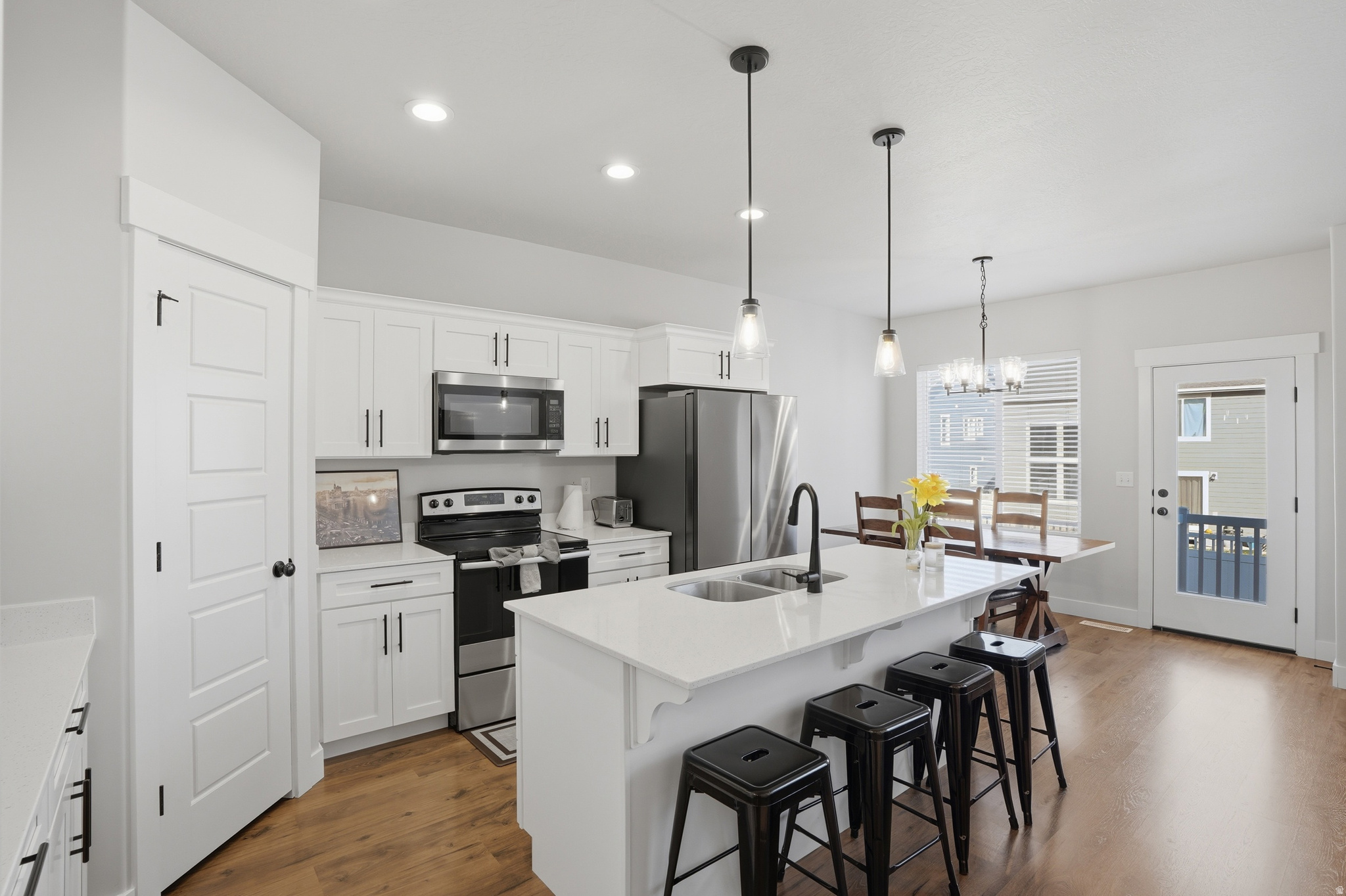 Welcome to Mountain Ridge! This well-maintained 3-bedroom, 3-bath townhome offers an open-concept layout with modern finishes and a bright, functional living space.  The main level features a seamless flow between kitchen, dining, and living areas-perfect for everyday living or entertaining. Upstairs includes a spacious primary suite with walk-in closet and private bath. The unfinished basement provides room to grow or additional storage.  Enjoy low-maintenance living with HOA amenities including a clubhouse, pool, fitness room, playgrounds, trails, and snow removal. Conveniently located near Mountain View Corridor, Blackridge Reservoir, and Mountain View Village.  Square footage figures are provided as a courtesy estimate only and were obtained from WFMLS.  Buyer is advised to obtain an independent measurement.