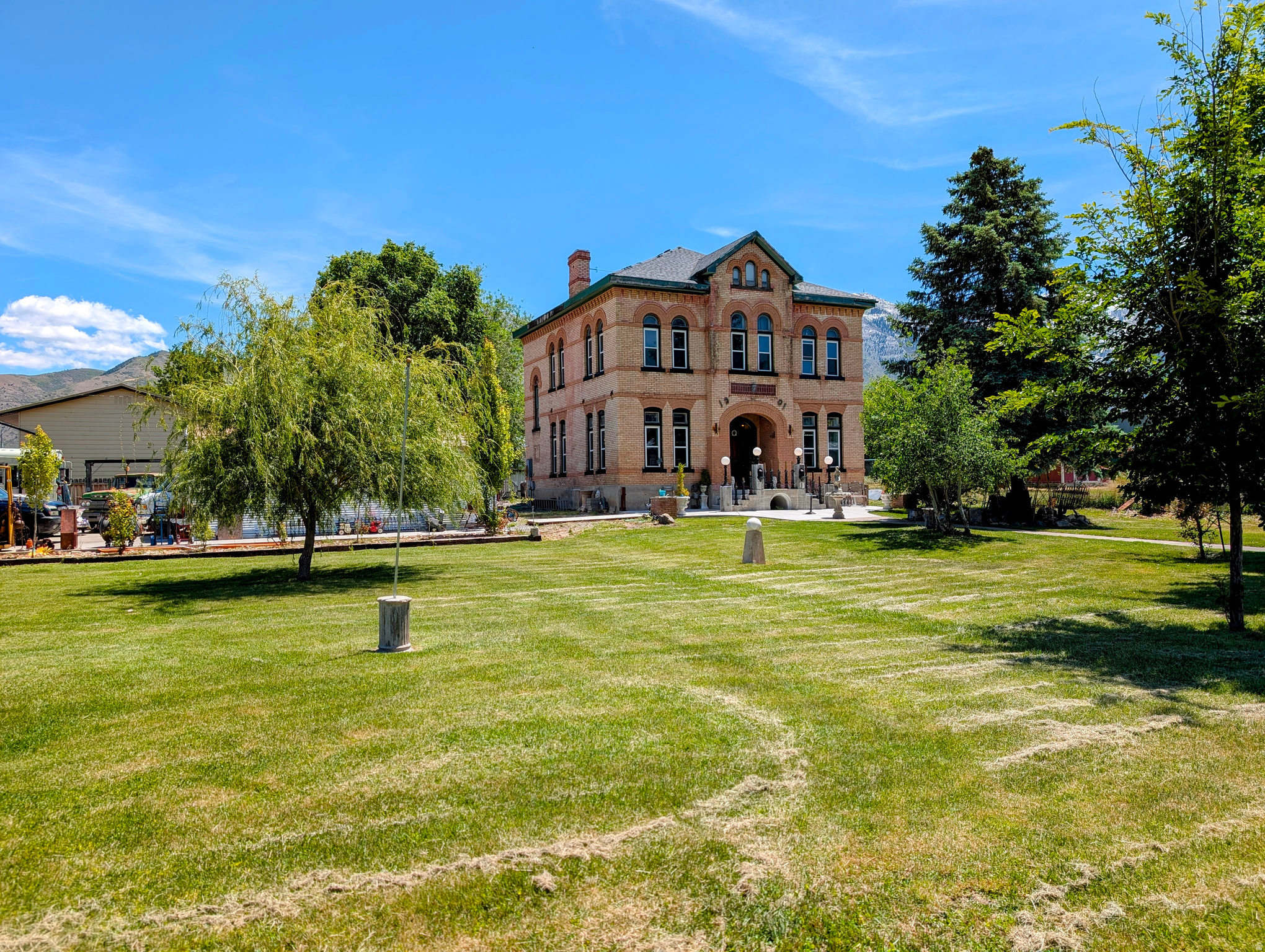 HUGE PRICE DROP!  What a unique home with a unique history.  This was originally the town hall, city offices, city jail (there are still markings from the bars on some of the windows) and city gathering place.  On nearly half an acre, this home has many modern updates while preserving the historical charm.  Tall ceilings throughout the home including vaults in all the second story bedrooms.  All 3 bedrooms have their own private bathrooms.  Main floor has great spaces from the family room, office/den, half bath, laundry room and the beautifully updated kitchen.  Electrical was updated, plumbing was updated, new windows installed (with transferable lifetime warranty), tankless water heater, newer furnace, details and touches from mosaic tiles, copper ceiling tiles, tin crown molding, antique trim, HUGE lot, 4 storage containers, HUGE car port, fantastic yard, next to the baseball fields and parks, incredible views and the list goes on!  Don't miss your once-in-a-lifetime chance to own a piece of history! Square footage figures are provided as a courtesy estimate only and were obtained from the Utah County Recorder.  Buyer is advised to obtain an independent measurement.