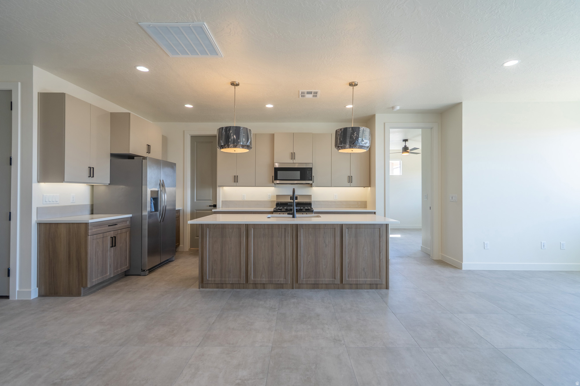 The Sole - This well-designed 4-bedroom, 2.5-bath home offers modern living with an open-concept layout connecting the spacious great room and stylish kitchen. Features include thermofoil cabinetry, granite countertops, a single-bowl stainless steel undermount sink, and a Frigidaire stainless steel appliance package with electric range, microwave hood, dishwasher, and refrigerator. Interior finishes include two-tone paint, LVP carpet in main living areas, and in bedrooms, can lighting throughout, and ceiling fans in the living room and bedrooms. Bathrooms feature Moen plumbing fixtures and custom tiled showers/tub surrounds. Additional highlights include a laundry room with sink cabinet, extended finished garage with 50-amp EV breaker and room for a workshop or toys, block walls, and backyard space. Community amenities include a pool, hot tub, pool house, pickleball court, playground, and RV parking. Builder incentives available with preferred lender. Qualified buyers may obtain:  Conventional 7/6 ARM  initial interest rate ~5.50% on an adjustable-rate mortgage (ARM), fixed 7 yrs, adjusts semiannually  FHA 5/1 ARM  initial interest rate ~4.75% on an adjustable-rate mortgage (ARM), fixed 5 yrs, adjusts annually Seller contributes 2.5% + lender contributes 1.5% (with Guild Mortgage), which may be used toward a temporary rate buydown, closing costs, and/or prepaids-reducing initial monthly payments. Lender Incentives available only when financing is obtained through Matt Hickman at Guild Mortgage.OAC. Rates subject to change. APR may be higher.