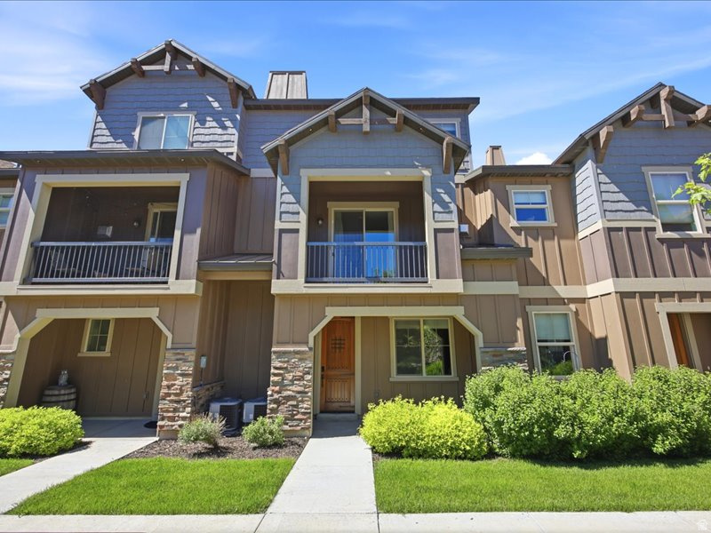 Perfectly positioned in Park's Edge near Jordanelle Reservoir, just 11 minutes from Deer Valley East Village and 12 minutes from Historic Main Street Park City, this updated mountain modern home offers year-round recreation, luxury living, and nightly rental flexibility. Whether you're searching for a primary residence, vacation retreat, or income-producing investment, this home checks every box. The floor plan creates privacy and functionality. The top floor is dedicated to a private primary retreat featuring an ensuite bathroom with separate soaking tub and shower, dual closets, and a dedicated den ideal for a home office. The main level is designed for gathering. The kitchen features granite countertops, a gas range, pantry, abundant storage, and ample workspace for everything from casual breakfasts to gourmet dinners. The great room with a cozy gas fireplace, flows to a private balcony where you can enjoy mountain air. An additional bedroom and full bathroom complete this level. Guests will appreciate the privacy of the lower-level ensuite bedroom, creating an ideal separation of space for family and visitors. The laundry room offers additional storage with cabinetry and space beneath the front-loading washer and dryer. The two-car garage is outfitted with epoxy flooring, ski storage, and an additional storage closet for all your mountain toys. Life extends well beyond your front door. Residents enjoy access to over 15 acres of open space with trails, expansive grassy fields, whether that means soccer with the kids, tossing a frisbee with the dog, or simply enjoying the outdoors. The community clubhouse features a theater room, fitness center, entertaining kitchen, billiards table, outdoor pool, and hot tub. Wake up and mountain bike directly from your doorstep. Spend afternoons boating, paddleboarding, or waterskiing on Jordanelle Reservoir. Hit the slopes at Deer Valley in minutes. Finish the day dining on Main Street before returning home to relax by the fire.