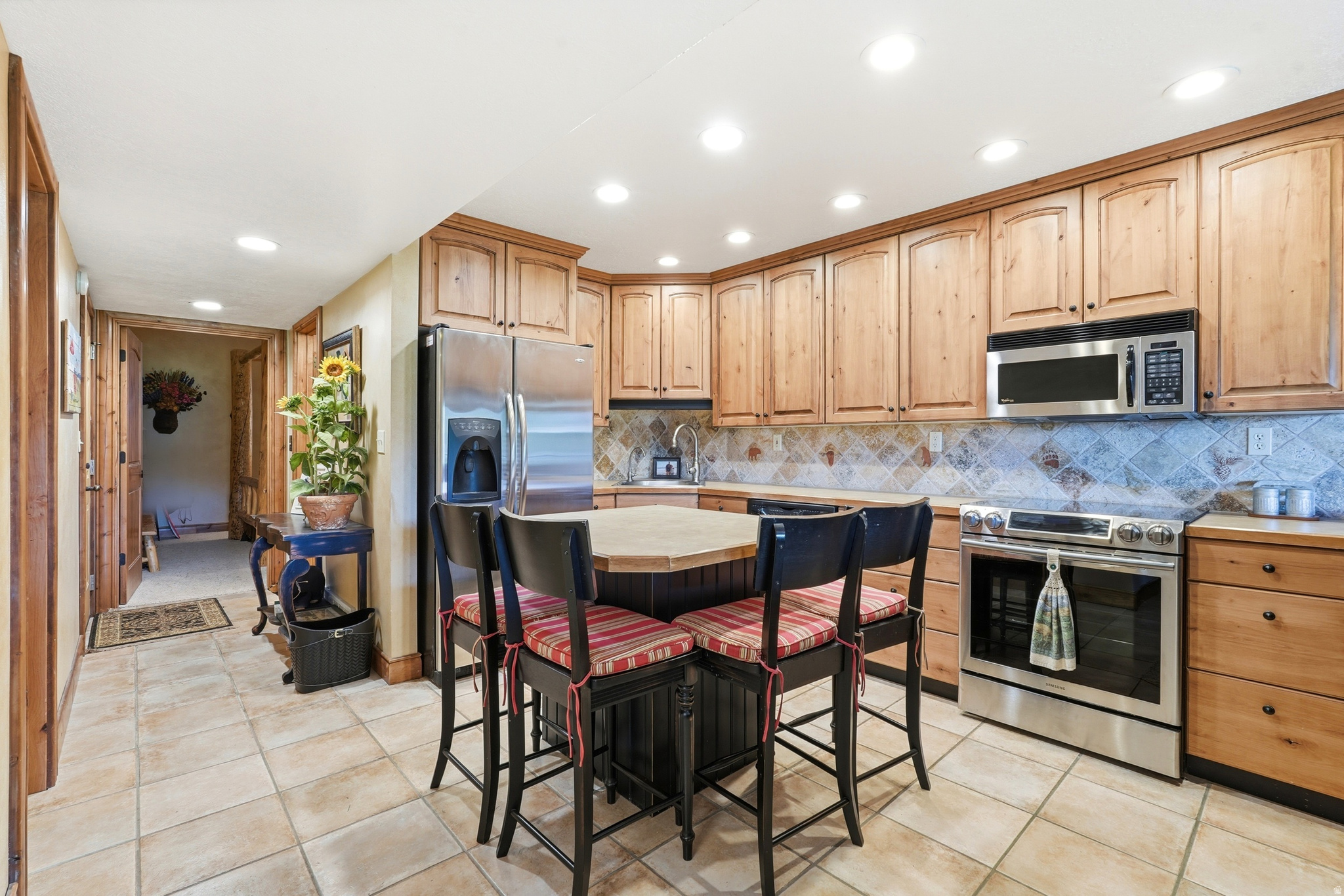 Rare opportunity to own a unique multi-level Bear Lake getaway with panoramic lake and mountain views, dual kitchens, and immediate enjoyment with no nightly rental reservations to honor - ready for use the day it records. This fully furnished condo spans both the 2nd and 3rd levels, offering approximately 1,400 sq ft with walkout patios on both levels. Owners also have the main level that is for sale so you could purchase both and have all levels if desired.  The main living level features 2 bedrooms, 2 full baths, spacious living area, knotty alder cabinetry, and a full kitchen with new tile flooring and custom tile finishes that continue through the bathrooms and tub/shower surrounds. The upper level adds an additional bedroom, full bath, kitchen, living area, and private patio, creating excellent flexibility for guests, multi-family use, or separate living space. Staircase access from the main living area patio leads directly to the shared lawn, beach, and resort amenities. Additional features include AC units throughout, Dish satellite service, televisions in both bedrooms, and a large living room TV perfectly positioned to relax while taking in views of Bear Lake. Ideal for personal enjoyment or a turnkey Bear Lake retreat. ****Square footage figures are provided as a courtesy estimate only and were obtained from county records. Buyer is advised to obtain an independent measurement.