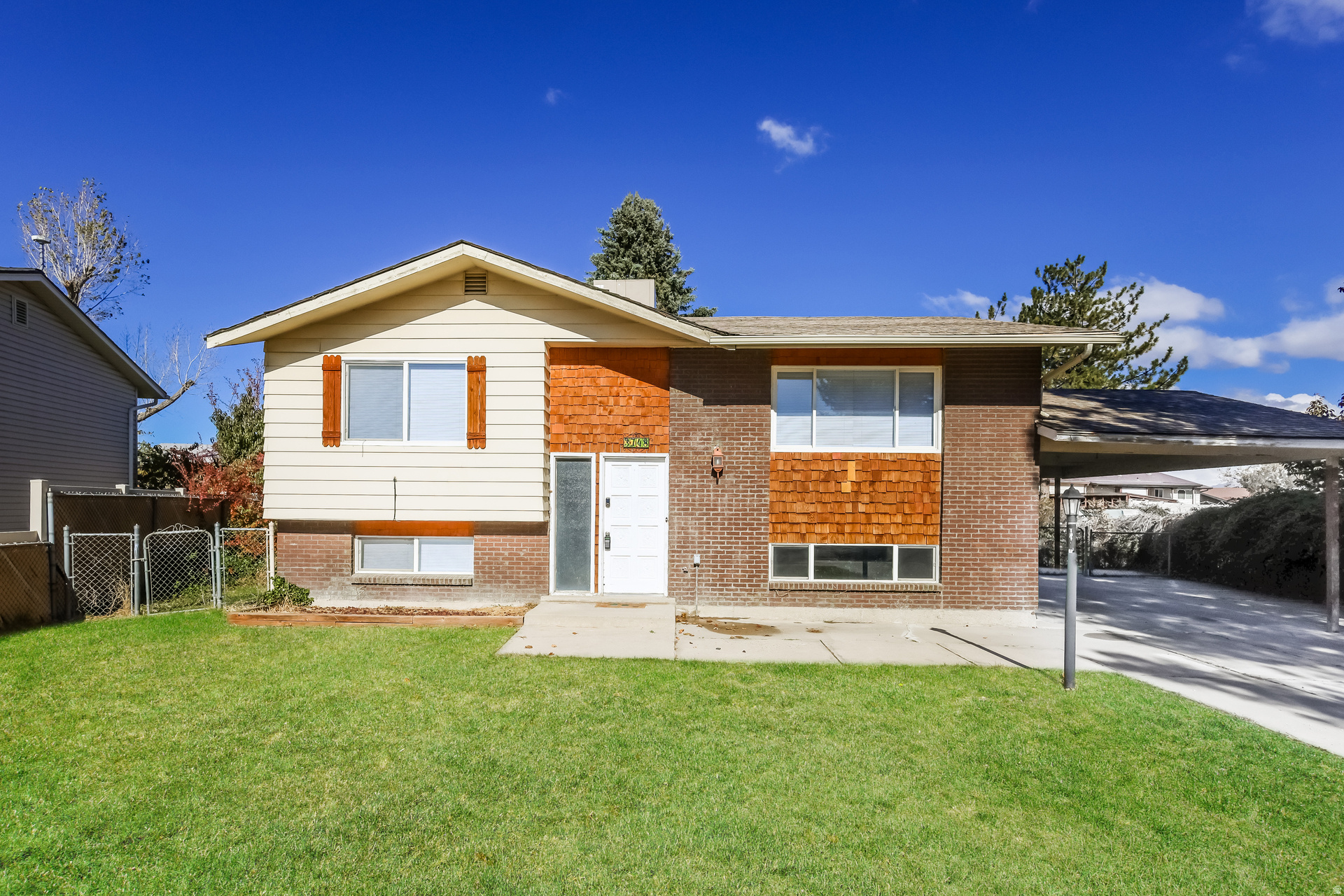 Discover the perfect blend of space, convenience, and opportunity in this inviting West Jordan home featuring 5 bedrooms, 2 bathrooms, and 1,741 square feet of comfortable living space. Ideally situated in an established neighborhood, you'll enjoy quick access to Jordan Landing's premier shopping, dining, and entertainment, along with nearby parks, schools, and commuter routes that make everyday living effortless. Inside, the flexible layout offers room for growing households, guests, hobbies, or a home office, while the attached 2-car carport provides convenient covered parking. With generous living spaces, a sought-after location, and easy access to everything the Salt Lake Valley has to offer, this home presents an exceptional opportunity to enjoy both comfort and convenience in one of West Jordan's most accessible areas.