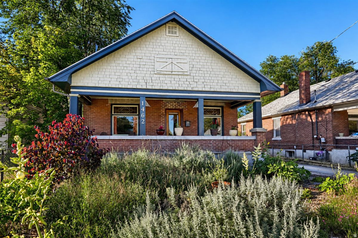 Thoughtfully preserved and rich with architectural character, this beautiful 1918 brick bungalow captures the craftsmanship and timeless appeal that define Rose Park's beloved historic homes. Original details abound, including stunning leaded glass windows, warm hardwood floors, and period millwork that reflect the enduring quality of early 20th-century design. An expansive front porch creates a gracious welcome and serves as an extension of the home's living space-perfect for enjoying quiet mornings and neighborhood sunsets. Inside, historic charm and modern functionality coexist seamlessly. The updated kitchen features a breakfast bar and thoughtfully integrated improvements and newer appliances that complement the home's original character while meeting the needs of contemporary living. Abundant natural light enhances the home's inviting atmosphere and highlights the beauty of its preserved architectural elements. The xeriscaped front yard showcases native plantings that provide year-round interest while conserving water. Beyond the home, an exceptionally large backyard offers a rare urban sanctuary. Mature fruit trees create a lush privacy for multiple outdoor gathering spaces, including a pergola and fire pit area ideal for entertaining. Garden enthusiasts will appreciate the established vegetable beds and chicken coop, creating endless opportunities for sustainable living and homesteading. With its remarkable blend of historic craftsmanship, thoughtful updates, and extraordinary outdoor space, this 1918 bungalow is a rare urban homestead minutes from the heart of the city. **Presently 600 North is under construction, traffic is being diverted to 500 North - it is usually not overly busy, nor do the busses run on the street**