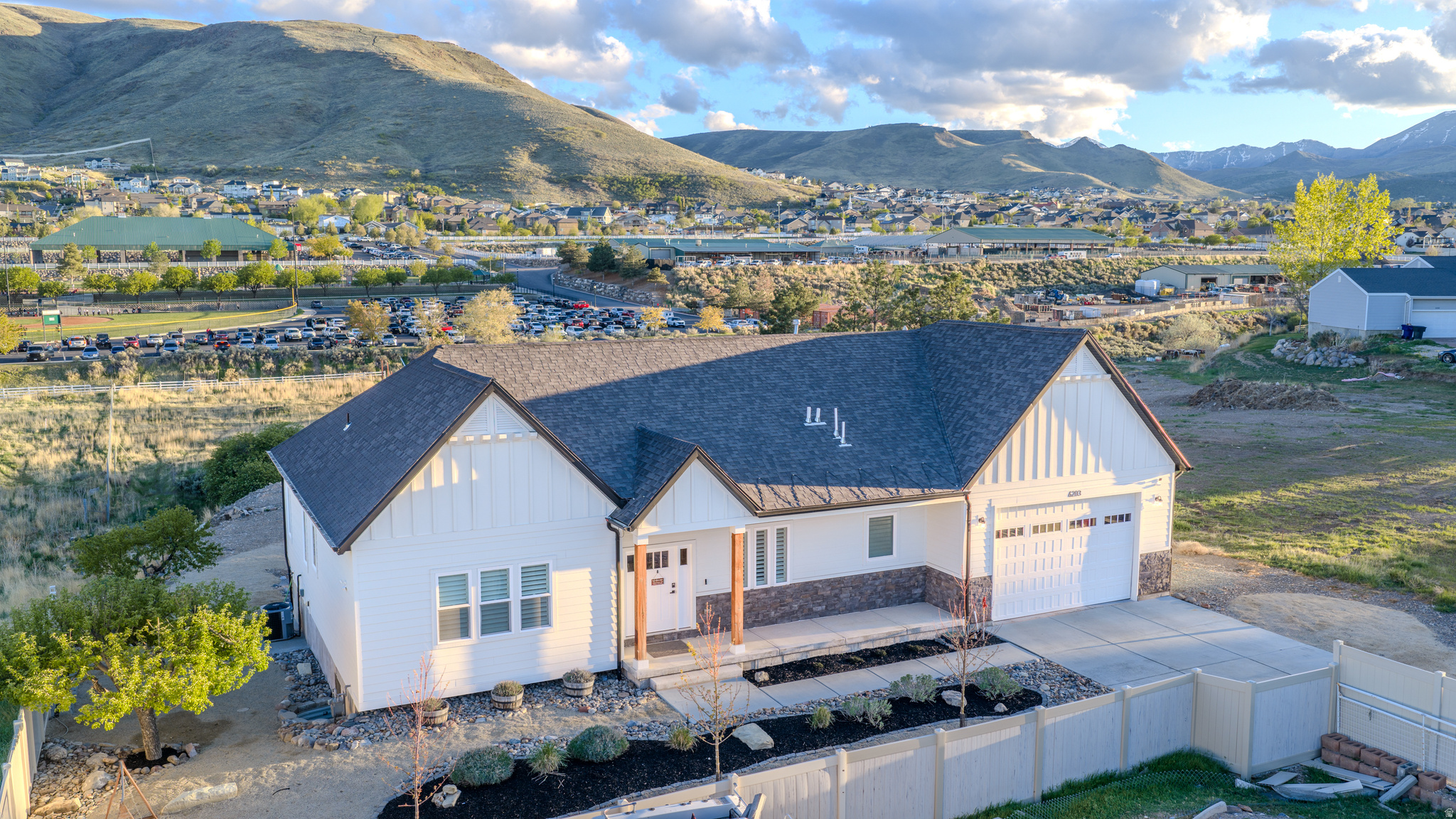 ***OPEN HOUSE SUNDAY MAY 17   11-1***Nearly new rambler completed in April 2021 on a private 1.19-acre flag lot with a seasonal stream, long driveway, and direct access to outstanding Herriman amenities. Tucked away from the street, this property backs Rose Creek Trail and sits directly next to Butterfield Park, known for its rodeo arenas, stall barn, baseball fields, playgrounds, volleyball courts, and open space. Fort Herriman Middle School is directly east of the lot.  Inside, the open main level features a spacious family room with fireplace, dining area, and double sliding glass doors leading to a covered deck with mountain views. The chef's kitchen offers abundant cabinetry and counter space, an oversized island, quartz countertops, farm sink, 6-burner stove with griddle and hood, oversized column-style refrigerator and freezer, pebble ice maker, and a large walk-in pantry. The main floor includes two bedrooms, including a spacious primary suite with freestanding tub, tiled shower with dual shower heads, separate toilet, and walk-in closet, plus another full bath with optional stacking washer/dryer hookups. The finished walk-out basement includes a large family room, play area, full bath, three large bedrooms, laundry room, and cold storage. Additional features include Hardie board siding, vinyl plank flooring, water softener, tankless water heater, mature apple and peach trees, and a 3-car garage with a 10-foot door. All information contained is provided for informational purposes only and is not guaranteed. Any square footage or room dimensions are approximate and are based on CubiCasa measurements that have not been independently verified. Any maps, drawings, parcel information, acreage, animal rights, uses, or restrictions are approximate or based on third-party or municipal sources and may not reflect exact legal boundaries or current regulations. Buyer is advised to verify all information directly with appropriate sources, including the city, county, utility providers, and licensed professionals, to the buyer's own satisfaction.