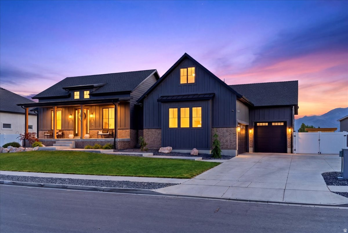 OPEN HOUSE CANCELLED MULTIPLE OFFERS... Stunning Custom designed Farmhouse Rambler-Ranch. The curb appeal alone will stop you in your tracks the moment you arrive. Step inside and you are welcomed by a warm and inviting entry that perfectly blends modern farmhouse charm with industrial-inspired finishes throughout. The open concept Family Room and Kitchen truly serve as the heart of the home. A dramatic floor-to-ceiling fireplace with a custom mantle creates a stunning focal point and gathering space. The Chef's Kitchen is thoughtfully designed with dark cabinetry, black accents, Quartz countertops with waterfall edge detail, stainless steel appliances including a Sub-Zero style refrigerator, gas cooktop, and double ovens. Large picture windows flood the space with natural light while showcasing unobstructed mountain and backyard views. This spacious home offers 5 bedrooms, 4 bathrooms, and a fully finished basement complete with a Theater Room. Theater screen and projector are included. The Main Floor Primary Suite feels like a spa-inspired retreat featuring a separate Euro glass shower, soaking tub, double vanities, and a walk-in closet. Designer wallpaper accents add warmth, character, and style to the space. Step outside to enjoy the covered back patio and fully fenced .40-acre lot. Whether hosting BBQs, relaxing around a cozy fire pit, gardening, or enjoying the chicken coop, this backyard was designed for country-style living and entertaining. You will love the peaceful, quiet country feel while still being just minutes from new schools, shopping, dining, and convenient freeway access. This home won't last long. Call now for you private showing.  Square footage figures are provided as a courtesy estimate only and were obtained from County .  Buyer is advised to obtain an independent measurement.