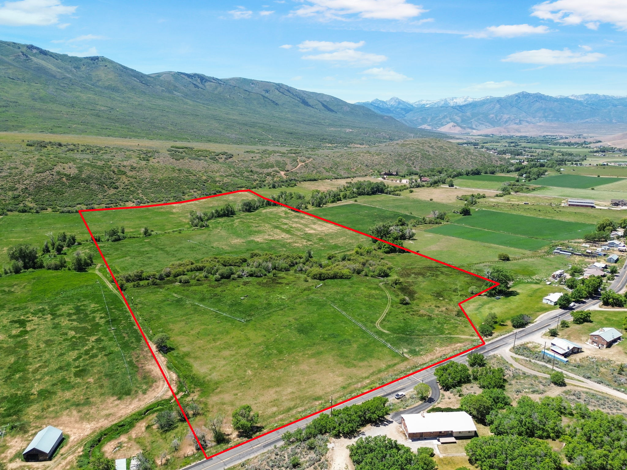 56-Acre Development Opportunity with Stream & Mountain Views Discover an exceptional 56-acre property offering breathtaking mountain views, a picturesque stream, and outstanding development potential. Zoned R-5, this unique parcel presents an excellent opportunity for a developer or investor seeking to create an exclusive enclave of luxury estate homes. The property's natural beauty, gentle terrain, and scenic setting make it ideally suited for approximately 810 premium five-acre estate lots, providing future homeowners with privacy, space, and stunning surroundings. With expansive vistas, abundant wildlife, and a tranquil country atmosphere, this property offers the perfect blend of rural living and convenient accessibility. Whether envisioned as a private estate community, equestrian-friendly development, or luxury countryside retreat, this rare offering provides flexibility, beauty, and significant long-term value. Opportunities to acquire large acreage with development potential, water features, and spectacular mountain views are increasingly rare. Don't miss the chance to create a remarkable legacy property in one of the area's most desirable settings. Buyer to verify acreage through Wasatch County. The acreage provided is an estimate only.