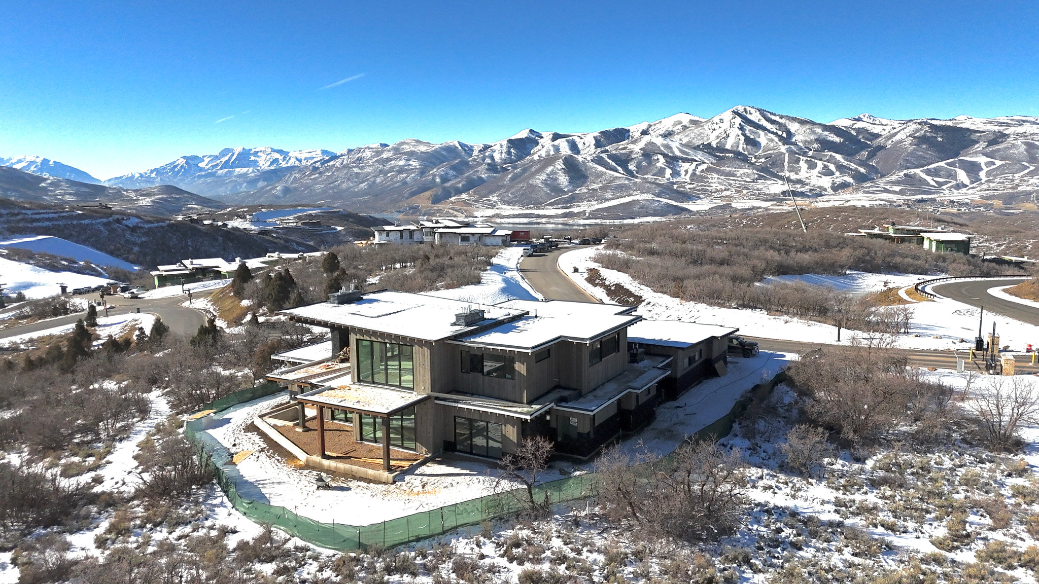 CONSTRUCTION COMPLETE JUNE 21, 2026. Big Canyon Homes is at it again! This extraordinary, custom new-construction in Tuhaye masterfully blends modern organic style with impeccable craftsmanship and thoughtfully curated, high-end design. Developed and built by the renowned Big Canyon Homes, this residence captures sweeping, unobstructed views of Mount Timpanogos, Deer Valley, and Jordanelle Reservoir, offering an exceptional mountain living experience. Spanning 6,279 square feet, every element of this home has been meticulously selected by one of Park City's premier luxury home designers to meet the highest standards of quality, style, and functionality. The heart of the home is a stunning gourmet kitchen featuring custom cabinetry, top-of-the-line appliances, and carefully sourced premium plumbing and lighting fixtures - all designed to elevate both everyday living and special occasions. The outdoor living spaces are truly next level, offering expansive heated patios and decks, a built-in hot tub, and a striking outdoor fireplace that invites gatherings under the stars. Multiple seating and dining areas provide the perfect setting to entertain, unwind, or simply soak in the spectacular golf course, mountain, and lake views. Every room in the home has been intentionally positioned to capture these picturesque surroundings, making this a true year-round mountain retreat. Designed for effortless entertaining and laid-back luxury, the oversized upper-level hangout room is complete with a sleek wet bar, designer beverage center, and ample room for a ping-pong or pool table. Radiant heat warms every inch of the home, seamlessly extending to the heated driveway and epoxy-coated garage floor for ultimate year-round comfort and convenience. This property includes a full Talisker Club Membership, granting access to exceptional amenities like golf, dining, spa services, and private mountain ski access at the exclusive Tower Club in Empire Pass.  If a construction project was in your future but that seems like too much time, money and effort we will consider your lot in trade!