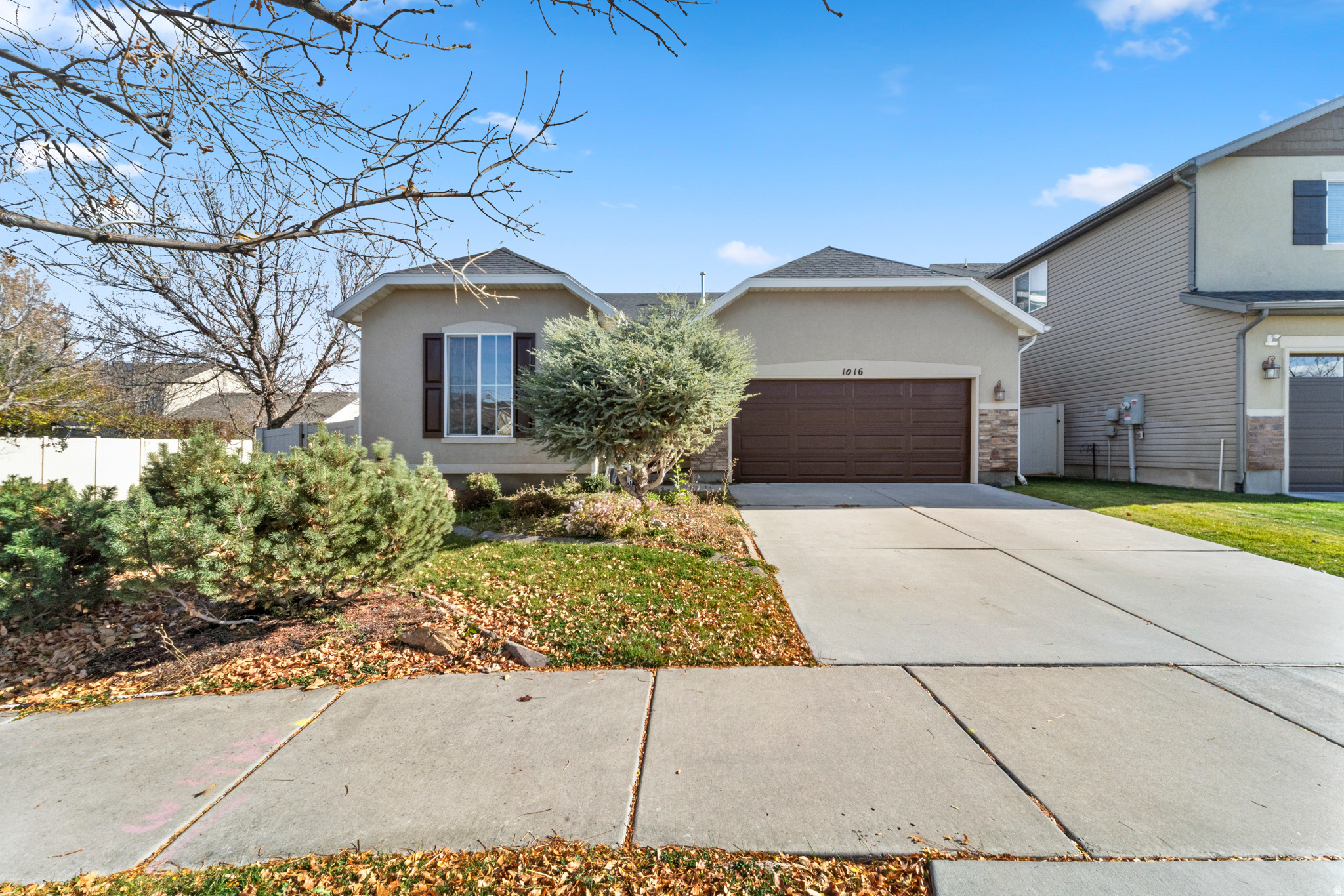 Welcome home to this beautifully maintained, single-level residence nestled in a quiet yet highly desirable North Salt Lake neighborhood. From the moment you arrive, the manicured landscaping and inviting curb appeal set the tone for the warmth and care found throughout the home. Inside, you'll find rich, dark hardwood-style flooring flowing through the main living areas, creating a modern, clean, and upscale feel. An open and functional layout is bathed in natural light, offering a bright and comfortable space perfect for both everyday living and entertaining. The kitchen has abundant cabinet storage, with an intuitive layout that continues to the dining and living spaces. The bedrooms are spacious and serene, with plenty of closet storage, providing the perfect retreat from a day's end. Step outside onto a private, fully-fenced backyard with a covered patio that's perfect for entertaining, relaxing, or enjoying Utah's beautiful seasons. The yard is very low-maintenance and offers both privacy and functionality. The garage is clean and well-kept, offering great space for storage or hobbies. Located mere minutes from parks, schools, walking trails, shopping, and quick freeway access, this home mixes suburban tranquility with unbeatable convenience to downtown Salt Lake City. This is a home that truly feels good the moment you walk in.