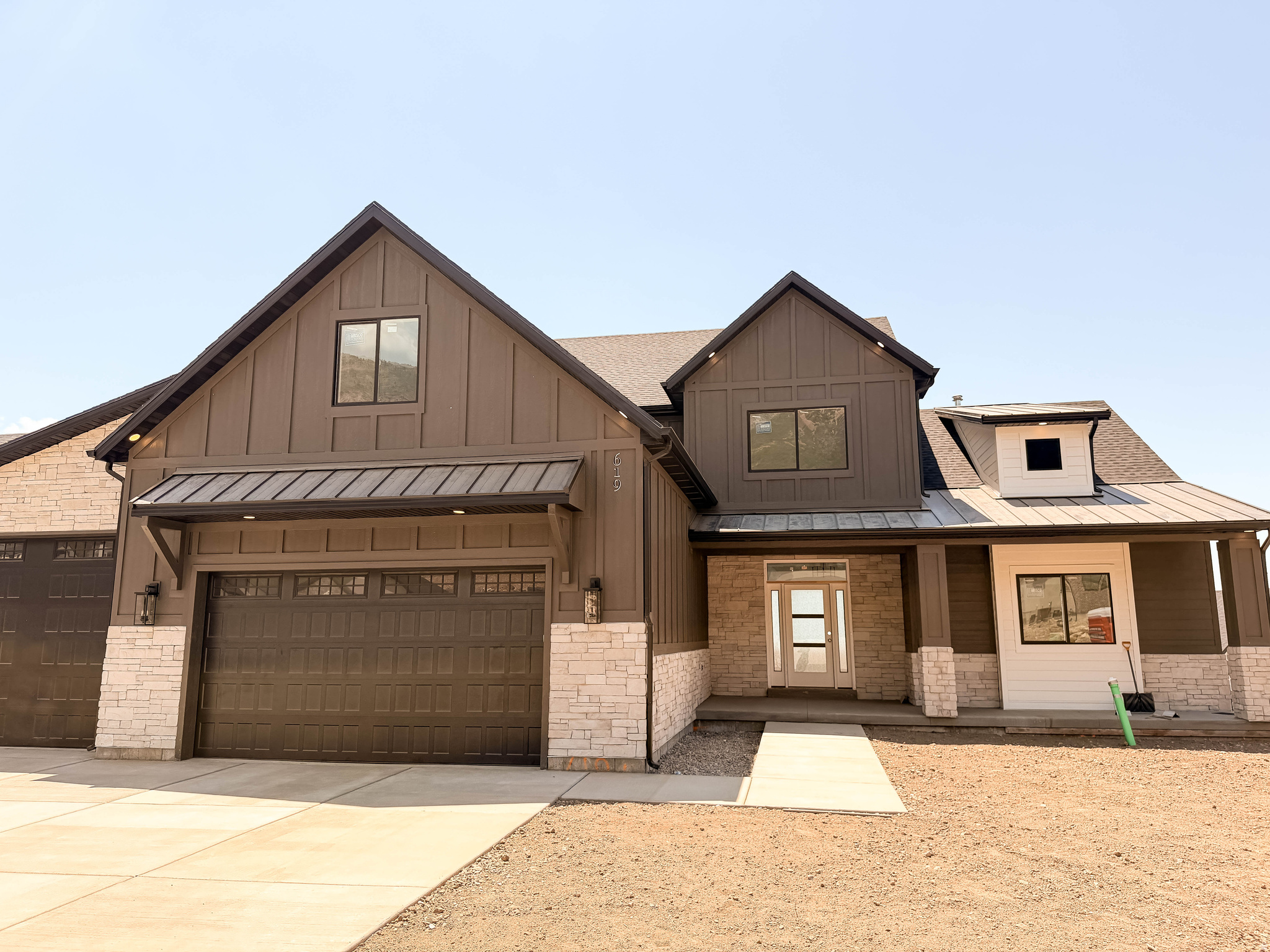 Step into this beautifully crafted 2story home, where sweeping valley and mountain views create a breathtaking backdrop for everyday living. The main level is designed for effortless living, featuring a serene primary suite complete with a spainspired bath and it's own private deck. The gourmet kitchen will impress with double ovens, pull-out trash cans, natural cabinetry, a decorative vent hood, and a spacious pantry. The great room welcomes you with a dramatic floortoceiling fireplace and expansive windows that flood the space with natural light. Half bath and thoughtfully placed laundry room off the garage elevate the home's functionality. Upstairs, you'll find four generous bedrooms, one full bath and an open staircase w/metal railing. Additional highlights include dual furnace/AC systems for yearround comfort, an oversized garage with EV plug, a water softener, and two covered decks and one covered patio for outdoor relaxation. The walkout basement opens the door to ADU possibilities and can be finished by the Builder to perfectly match your vision.
