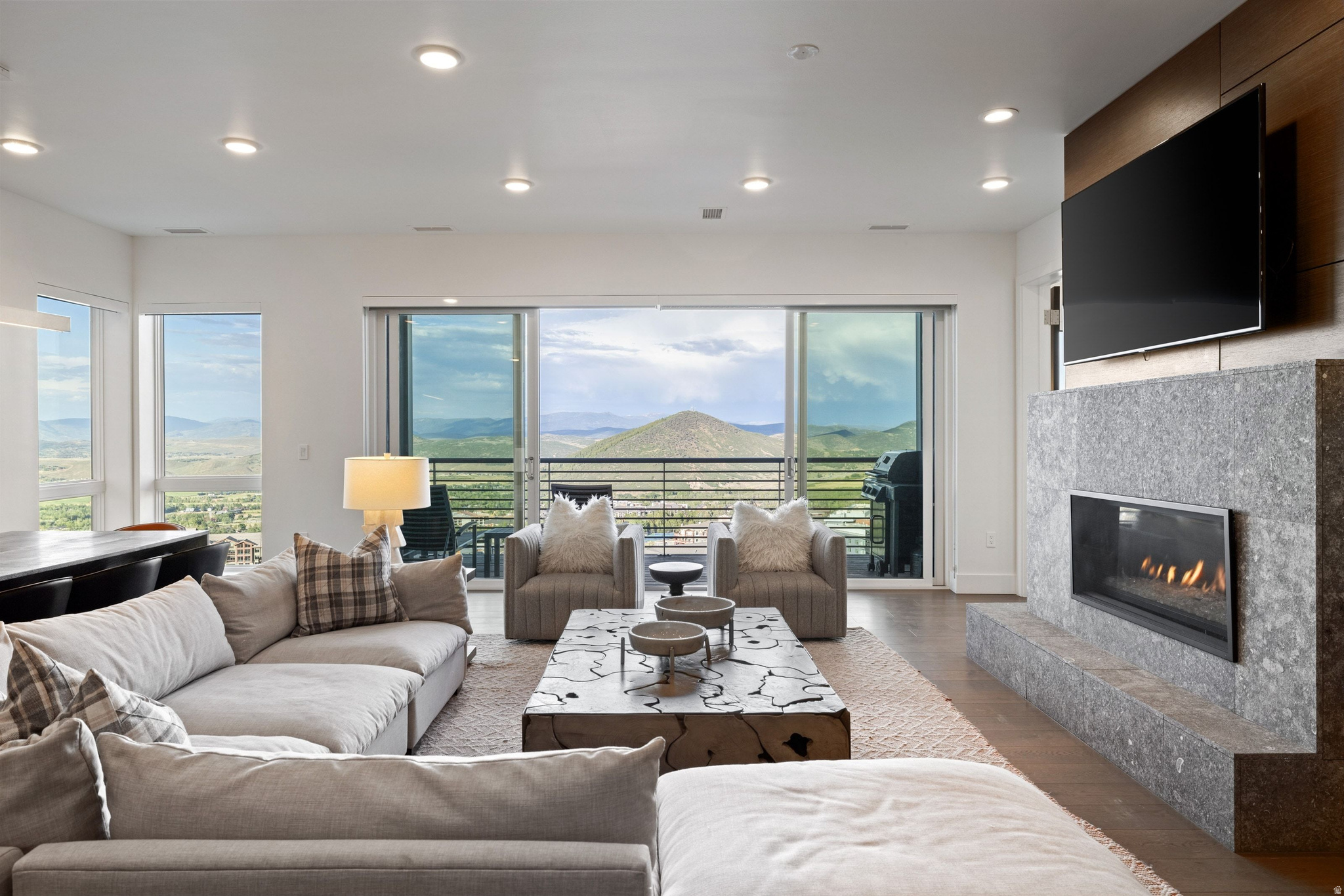 Perched on Apex Residences' coveted Overlook Level, this exceptional condo flat is a premier mountain retreat capturing sweeping east-facing views across the Snyderville Basin to the Uinta Mountains, Iron Mountain, and the ski slopes of Canyons Village. Framed by walls of glass, the ever-changing landscape becomes the backdrop to daily life-from quiet sunrises with coffee to evening aprs watching the lights of the valley and Canyons Village below come alive. Designed for effortless mountain living, the open great room seamlessly connects the kitchen, dining, and living areas onto the large deck, creating an inviting setting for entertaining in every season. The privately positioned primary suite offers a peaceful retreat, offering big corner views, while the remaining guest suites are thoughtfully separated to provide comfort and privacy for family and visitors alike though the view is not sacrificed from any bedroom. A generous walk-in pantry, abundant storage spaces, multiple walk-in closets, and a private ski room ensure the residence functions as beautifully as it lives, whether you chose to place the property on the rental pool or keep it for personal use. Just beyond your door, enjoy true ski-in/ski-out access in the winter and miles of hiking and mountain biking trails throughout the summer. After a day of adventure, return to Apex's private clubhouse, where a year-round heated pool, oversized hot tub, fitness and wellness facilities, owner's lounge, kids' room, and thoughtfully curated amenities make every season feel like a luxury resort. Professionally maintained year-round, Apex offers a true lock-and-leave lifestyle in one of Park City's premier mountain communities. With two assigned parking spaces, the property offers the unique option of keeping a personal vehicle while leaving space for tenants when you are not in residence.