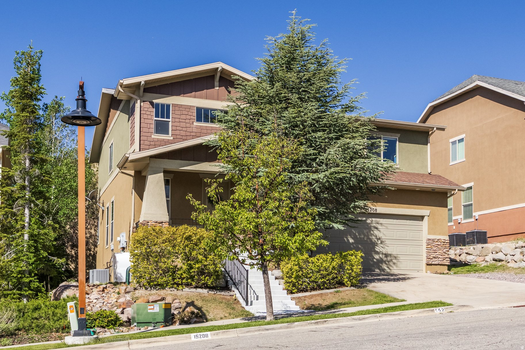Located in the sought-after neighborhood in Suncrest, this beautiful home sits on the quiet side of the mountain and offers breathtaking views of Lone Peak and Mt. Timpanogos from the primary suite, kitchen, dining room, and front porch. The vaulted entry welcomes you into slate floors, granite countertops, and an open floor plan with 9-foot ceilings on both the main and basement levels. The large kitchen features upgraded appliances and a huge island, the living room opens to a Trex deck with a built-in hot tub, and the primary suite includes a large walk-in closet with space for a sitting nook or home office. Three additional large bedrooms, a huge laundry room, and a second-level loft round out the upper levels. The fully finished basement adds a family room, full bath, conforming bedroom, and rough-in plumbing already in place for a future kitchen, making it ideal for a mother-in-law apartment. Central vac, built-in surround sound, and custom carpentry throughout. The two-car garage features extra height plus a bonus nook of nearly 7x18 feet. Just around the corner, Signature Park offers a walking trail, pickleball court, and open green space, and stepping outside puts you directly on 40+ miles of trails connecting to Corner Canyon for world-class hiking and biking. HOA includes cable, high-speed internet, and a clubhouse with fitness room, pool, hot tubs, basketball, tennis and pickletball courts.