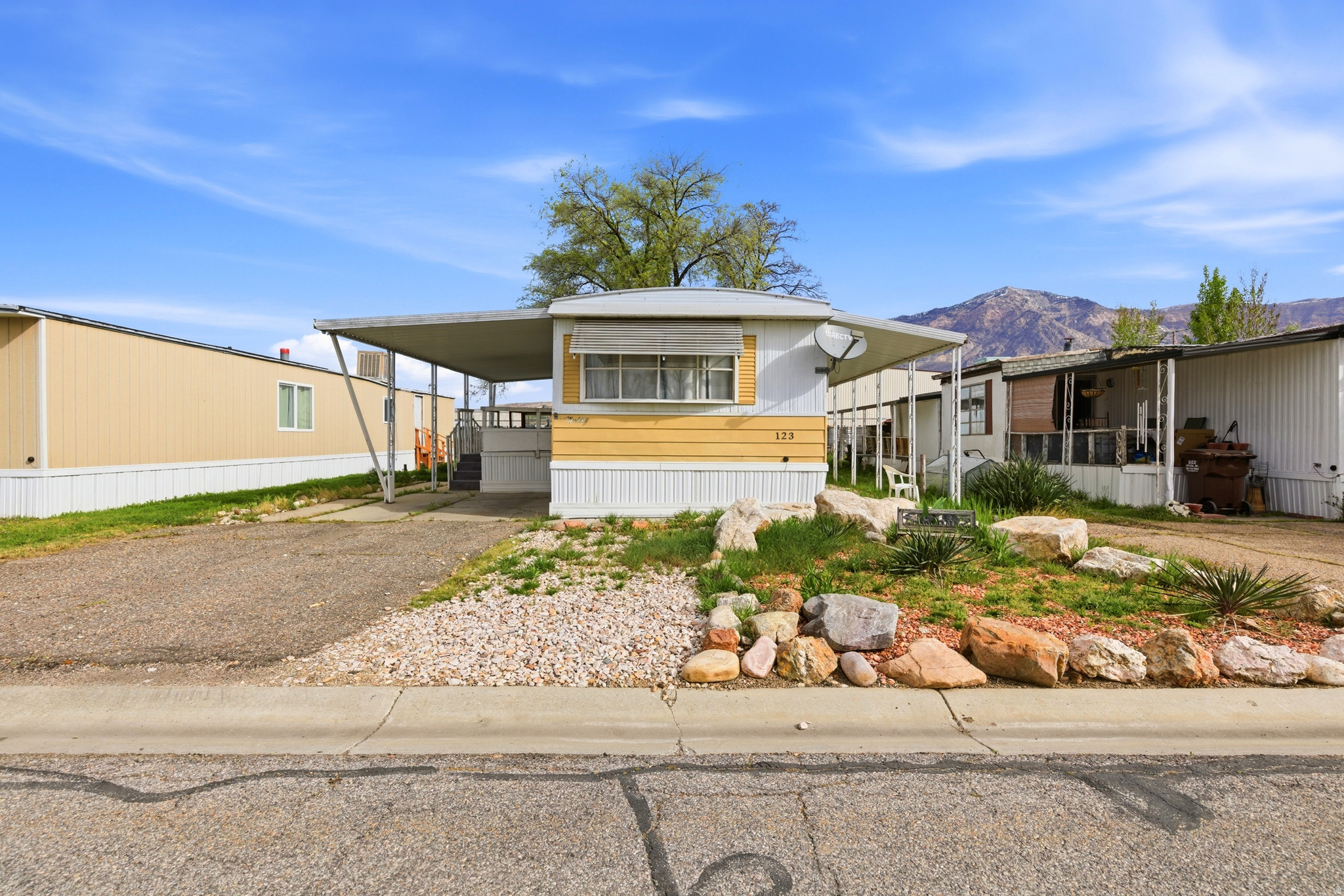 Charming 2 bedroom, 2 bathroom mobile home in Pleasant View offering beautiful views and a well designed layout. Features include newer water heater and furnace, updated cabinet doors and drawers, waterproof vinyl plank flooring, and newer skirting.  Each bedroom has its own designated bathroom, with the primary featuring a large soaking tub. Ample built-in storage throughout, including a lighted curio cabinet. Yard with mature tree, patio, and storage shed. Covered carport plus three additional parking spaces. ADA ramp at rear entry. Located in a well-managed community. Schedule your showing today.   Square footage figures are provided as a courtesy estimate only and were obtained from County records.  Buyer is advised to obtain an independent measurement.