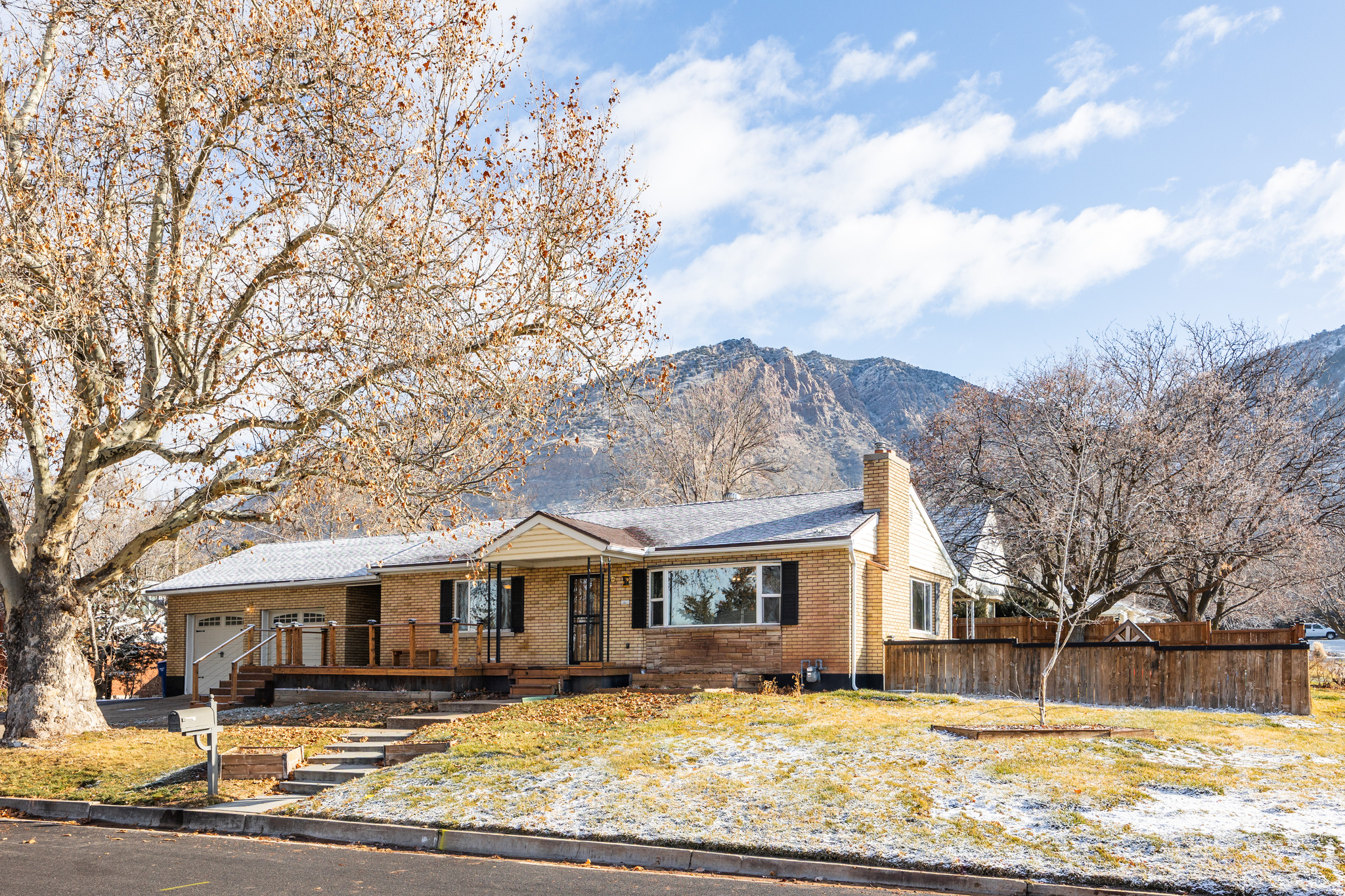 Sitting in a prime location just blocks from the 29th Street trailhead, you'll find this ranch-style home, as well-maintained and cozy as they come. This neighborhood is both quiet and walkable, making the perfect place to settle in-get to know your neighbors on daily strolls, or greet them from the roomy front porch that's been added to the home. Inside, you'll find a bright and welcoming space with some brick details and a fireplace that anchors the living area and lends a bit of warmth. The kitchen is just adjacent, touting ample space in the cute green cupboards, a tile backsplash, and a large window that overlooks the back yard, which can also be accessed via a set of sliding doors off the dining area. The basement level is roomy, to say the least, and a large bathroom has been remodeled to perfection, lending the possibility of quiet nights in the oversized tub. The water heater, electrical panel, and rain gutters here are all new, as well, so the home is definitely move-in ready with minimal upkeep. The garage-separate from the home by a short breezeway that also connects the front and back yards-has plenty of room for two cars and some storage, but there's also a pad to the side for additional parking, if needed, and a two-story storage shed in the back yard affords all the room you need for additional tools, toys, or projects. In short, this property has everything you need for easy, comfortable, convenient living.