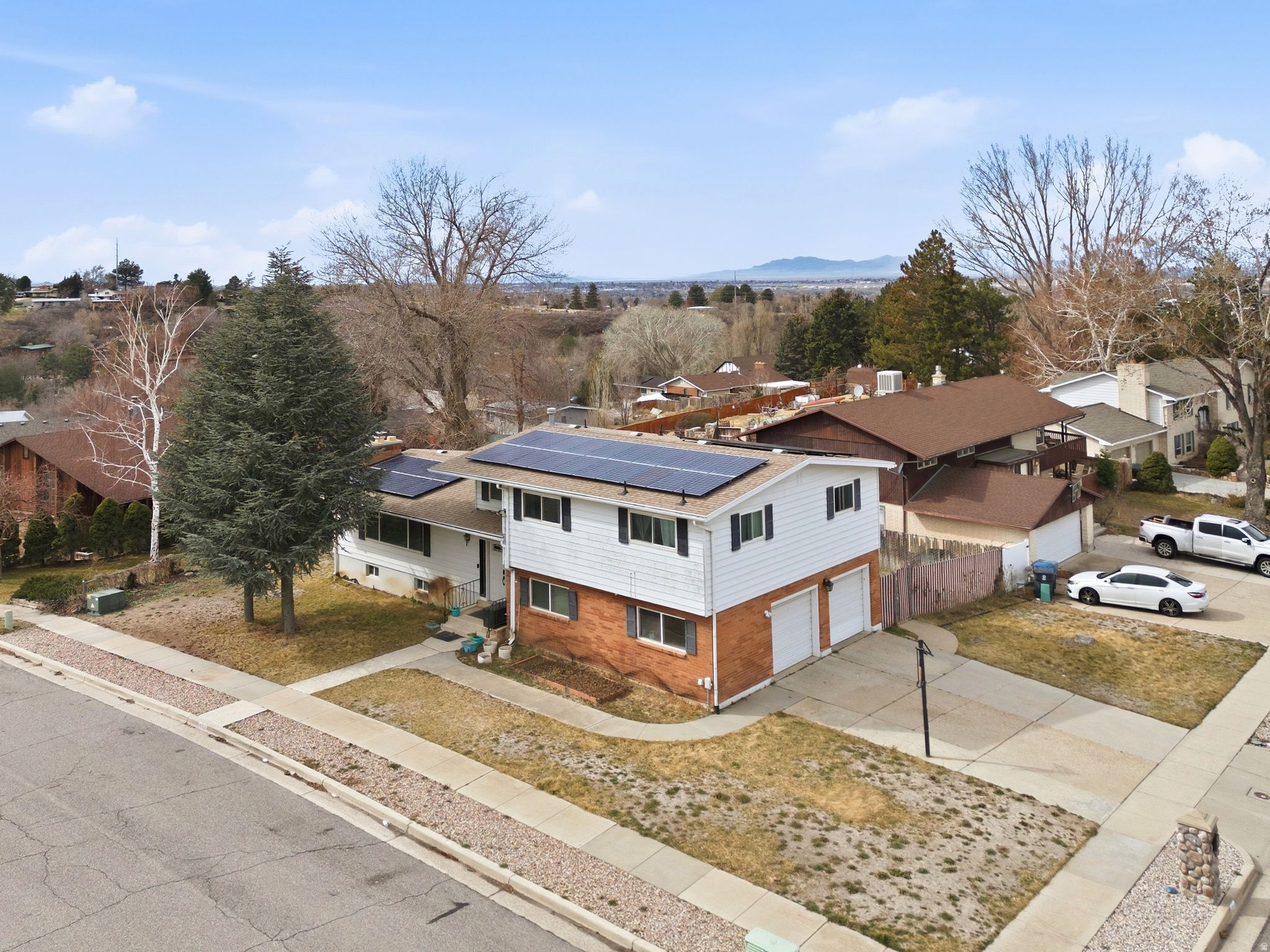 ***Assumable Loan 4%***Price  Improvement!! Welcome to this spacious South Ogden home featuring beautiful mountain views and a versatile floor plan designed for comfortable living. Offering 4 bedrooms and 3.5 bathrooms, this home includes three separate living areas plus a bright sunroom, providing plenty of space for a variety of needs.  The main-floor laundry adds convenience, while the updated kitchen showcases an impressive 11-foot granite island, cherry cabinetry, and abundant workspace. All bathrooms and the kitchen have been updated within the past 510 years.  Major system updates include paid-off solar panels, a newer roof installed at the same time as the solar system, a furnace and air conditioning condenser that are less than 10 years old, and a water heater replaced in the last year. New carpet has been installed throughout the home, and the fully finished basement offers additional living and entertaining space.  Step outside to enjoy the Trex deck, added approximately seven years ago, perfect for outdoor dining and gatherings while taking in the mountain views.  Conveniently located near shopping, healthcare facilities, Weber State University, Hill Air Force Base, and with easy access to Highway 89, this well-maintained home combines space, updates, and an excellent location.