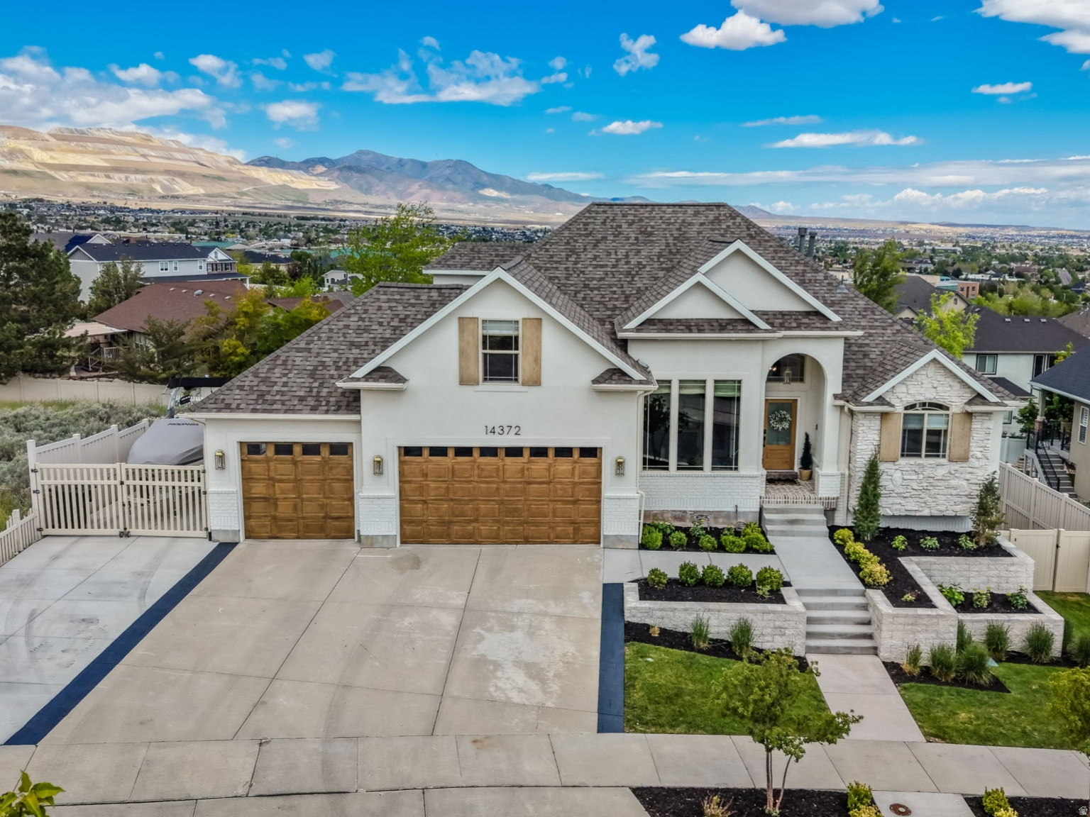 VIEWS, VIEWS and UPDATED to BRAND NEW!!  This fully remodeled custom home was redesigned with exceptional attention to every detail and is full of so many high-end finishes!!  Inside and out, the home has been updated to new while showcasing the breathtaking panoramic views of the mountains and valley.  The open floor plan features soaring two-story picture windows, a stunning custom fireplace, and a beautifully redesigned chef's kitchen with a butler's pantry, custom cabinetry, porcelain countertops, and premium gourmet appliances. Extensive upgrades include all new plumbing, electrical, flooring, trim, and finishes throughout the entire home.  The main-floor primary suite is a luxurious retreat with its own gas fireplace, spa-inspired bathroom featuring a freestanding tub, oversized walk-in shower, custom-designed closet and amazing views. Every bathroom in the home has been fully updated with new tile, cabinetry, plumbing fixtures, and designer finishes.  The fully updated basement includes a second kitchen with new cabinetry and countertops, a custom fireplace, an ensuite bedroom and new bathroom, exercise room, and two full bathrooms, creating the perfect space for entertaining or multi-generational living.  Additional upgrades include a new roof, new exterior, professionally landscaped yard, and a 50-foot RV parking pad.   This home combines luxury, functionality, and truly unmatched views in a setting that must be seen to be appreciated.  All furniture is available for purchase or negotiable with the sale.  No HOA. Must see to fully appreciate this beautiful home!!