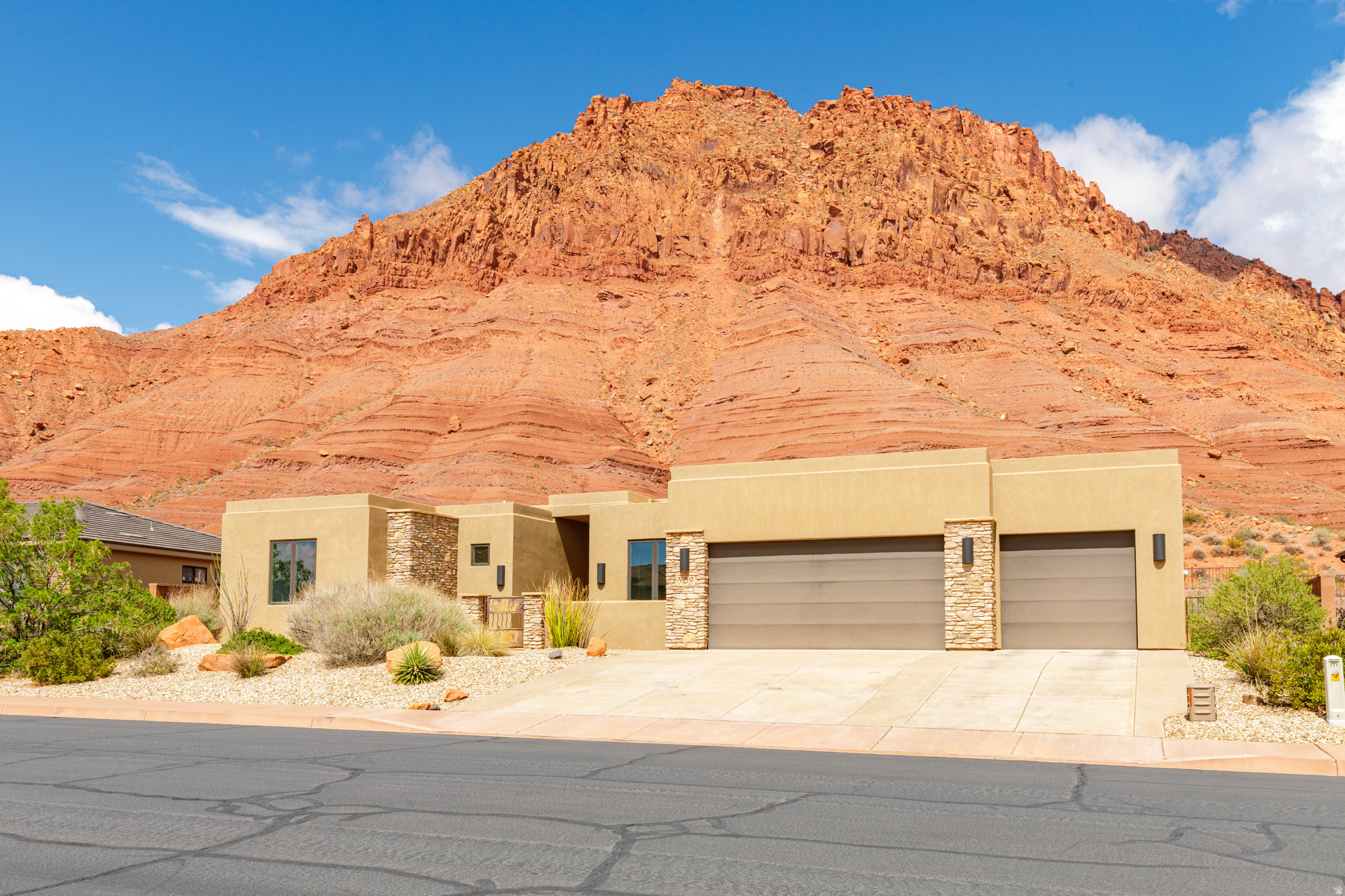 Million dollar views for under $800,000! Nestled against stunning red rock cliffs, this elegant home offers unparalleled views and modern comfort. Biking and walking trails in your backyard! The open living area, bathed in natural light captures the outdoor view. The kitchen is equipped with custom Hickory cabinetry, stainless steel appliances, and a spacious island, perfect for entertaining. Relax in the expansive master suite, complete with a luxurious soaking tub and unreal views. Three additional bedrooms provide ample space for family or guests. Home is pre-plumbed for central vac. Storage is abundant. Step outside to the rooftop terrace, ideal for enjoying breathtaking sunsets and starry nights. The low-maintenance xeriscaped yard compliments its natural surroundings and offers more time to appreciate the serene landscape. With a three-car garage and modern amenities throughout, this home is a rare find in a sought-after location with the famous red rock views. Don't miss your chance to make it yours!