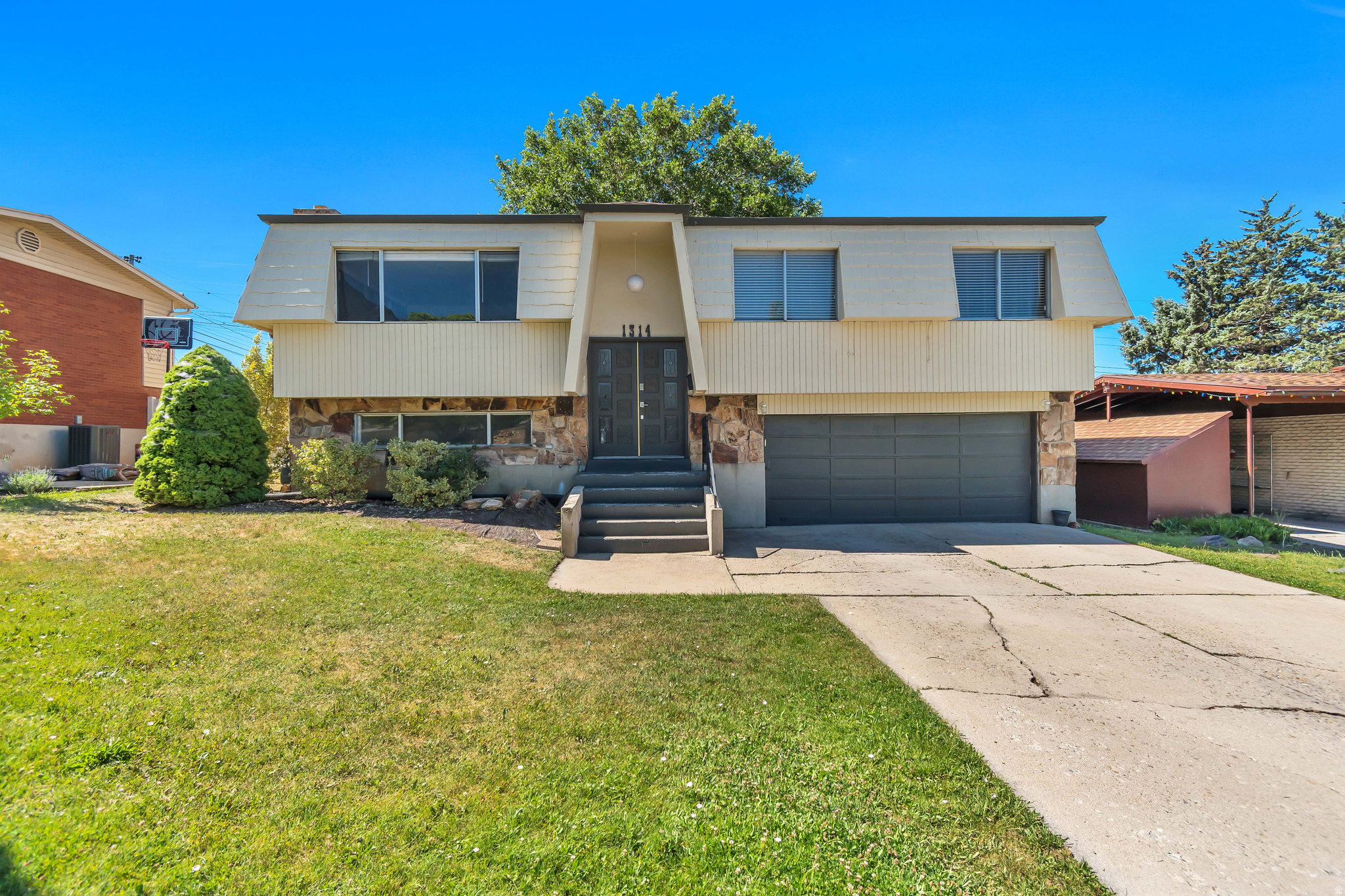 Located in a desirable east bench neighborhood, this home offers comfort, space, and a beautiful setting both inside and out. The large living room features a picture windows that fills the home with natural light, the kitchen includes a sliding glass door leading to a spacious two-tier deck, perfect for entertaining, relaxing under the shade of the large mature trees, primary suite, family room providing additional living space, and a garage adds convenience and storage. With its great living areas, and inviting outdoor space, this home offers the perfect combination of comfort and functionality.