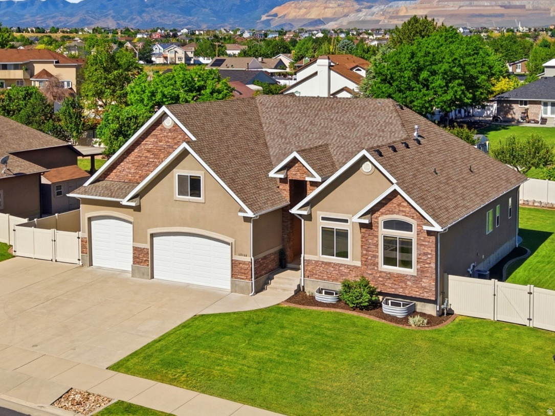 Conveniently located near shopping, restaurants, Costco, hospitals, schools, Bangerter Hwy, and walking paths right outside your front door. This meticulously maintained rambler features engineered hardwood flooring throughout the main level, vaulted ceilings, and abundant windows that fill the home with natural light.  Enjoy year-round relaxation in the enclosed patio. The spacious garage and RV parking provide plenty of room for boats, motorcycles, ATV's and other recreational toys!   Designed with entertaining in mind, this home boasts generous indoor and outdoor living spaces.  This one is a must see!