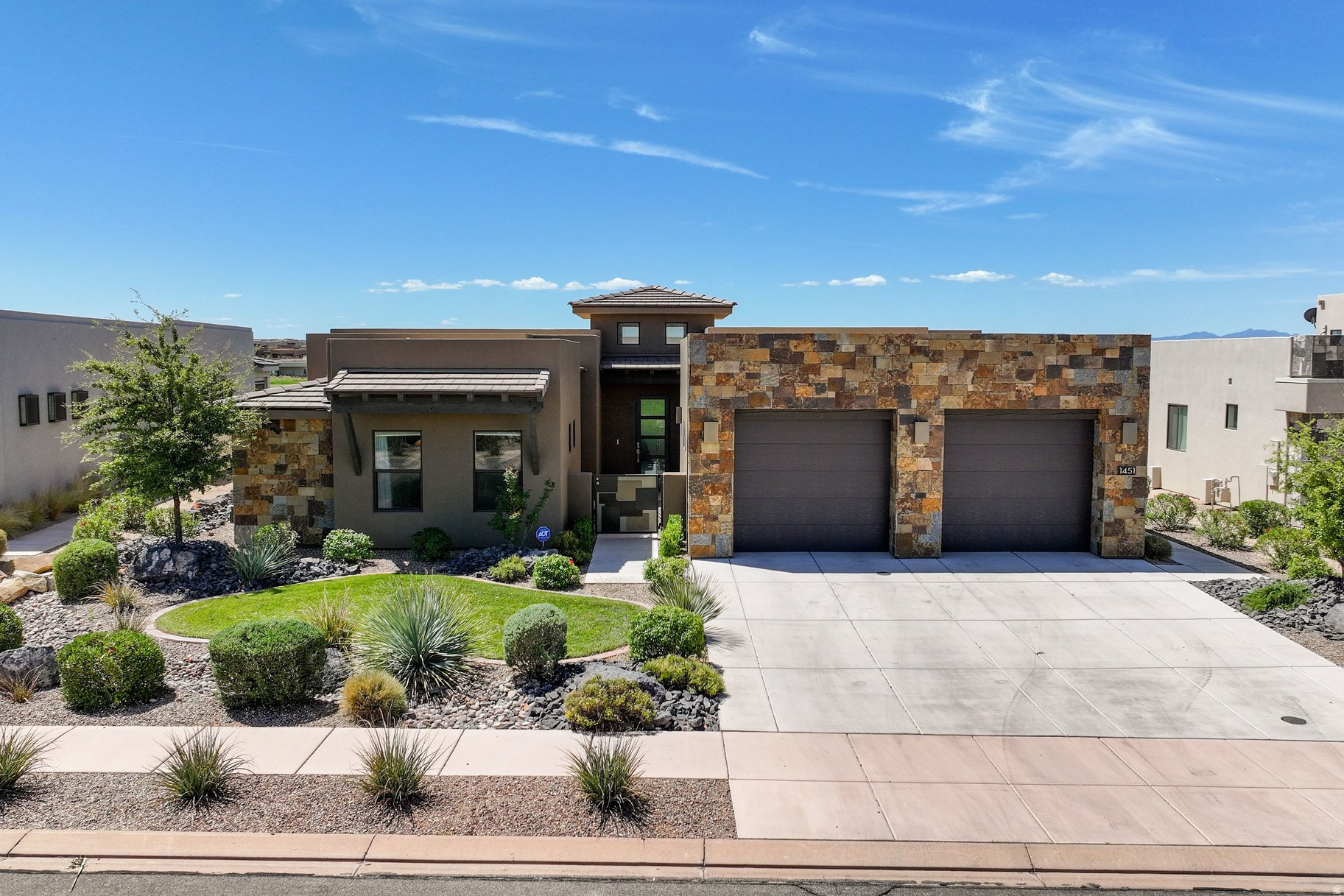 Experience elevated desert living in this short term rental zoned exceptional 5 bedroom, 5 bathroom, 4,095 square-foot luxury residence perfectly positioned along the 1st fairways of one of Southern Utah's premier golf communities. Built in 2021, this thoughtfully designed home offers the perfect blend of sophisticated architecture, resort-style living, and investment potential. Designed to maximize both comfort and scenery, the home features expansive open-concept living spaces filled with natural light, high ceilings, designer finishes, stackable sliding door and lots of windows that frame breathtaking views of the Ledges golf course, surrounding mesas, and iconic Southern Utah red rock landscapes. The gourmet kitchen serves as the heart of the home, showcasing Kitchenaid appliances, quartz countertop, high-end cabinets and flowing seamlessly into the dining and great room areas, creating an ideal setting for entertaining family and friends. The spacious primary suite offers a private retreat with stunning views, a luxurious spa-inspired bath, and generous closet space, while additional guest suites provide comfort and privacy for family and visitors. Every detail has been carefully curated to deliver a refined yet relaxed desert-modern aesthetic. Outdoor living is equally impressive, featuring a covered deck and patio with a large pool (15' x 30'), gas fire pit, and putting green designed to capture panoramic golf course and mountain vistas. Whether enjoying morning coffee overlooking the fairways, entertaining guests at sunset, or simply relaxing beneath Southern Utah's remarkable skies, these outdoor spaces create an extension of the home's luxurious interior. Furniture package included with a few exceptions.  Beyond the residence itself, owners enjoy access to an unmatched lifestyle. The community features a clubhouse with an event space and fitness equipment, as well as community pool and pickleball courts. Located within a highly sought-after resort community, residents are just moments from golf, scenic walking and biking trails, fitness amenities, dining, and recreation. The property's prime location also provides convenient access to downtown St. George, Snow Canyon State Park, Zion National Park, Sand Hollow Reservoir, world-class hiking, mountain biking, and endless outdoor adventure. Whether you're seeking a luxury primary residence, a lock-and-leave second home, or an income-producing vacation property, this remarkable offering presents a rare opportunity to enjoy the very best of Southern Utah living, surrounded by spectacular views and resort-style amenities.  All information herein is deemed reliable but is not guaranteed. Buyer is responsible to verify all listing information, including square feet/acreage, to the buyer's own satisfaction.