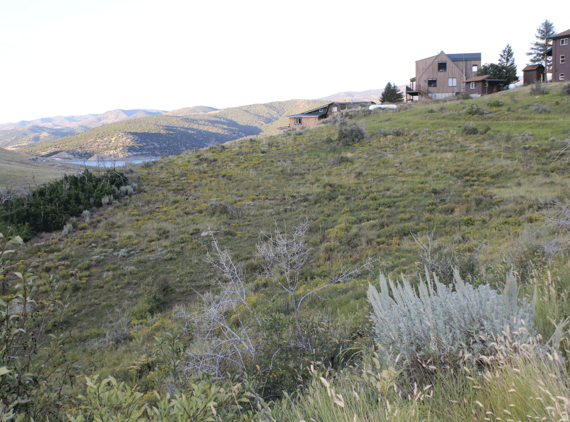 Secure a highly usable homesite just minutes from Rockport Reservoir. This gently sloping lot offers excellent buildability, expansive mountain views, and potential lake views from a future two-story home. Valuable groundwork has already been completed, including a survey, perc test, and available house plans-saving time and upfront cost. Seasonal trailer use is permitted, allowing for immediate recreational enjoyment while planning your future build. Located in one of the more accessible areas of Rockport Estates with year-round access and close proximity to boating, fishing, and outdoor recreation. No water meter is currently installed; however, the seller is actively involved in HOA meetings where future meter availability has been discussed. Buyer to verify. Thoughtfully priced to reflect current water status, this property stands out from other lots without water by offering completed due diligence and added flexibility for use and future planning. An ideal opportunity for buyers looking to secure land now with preparation already in place and potential for long-term upside.