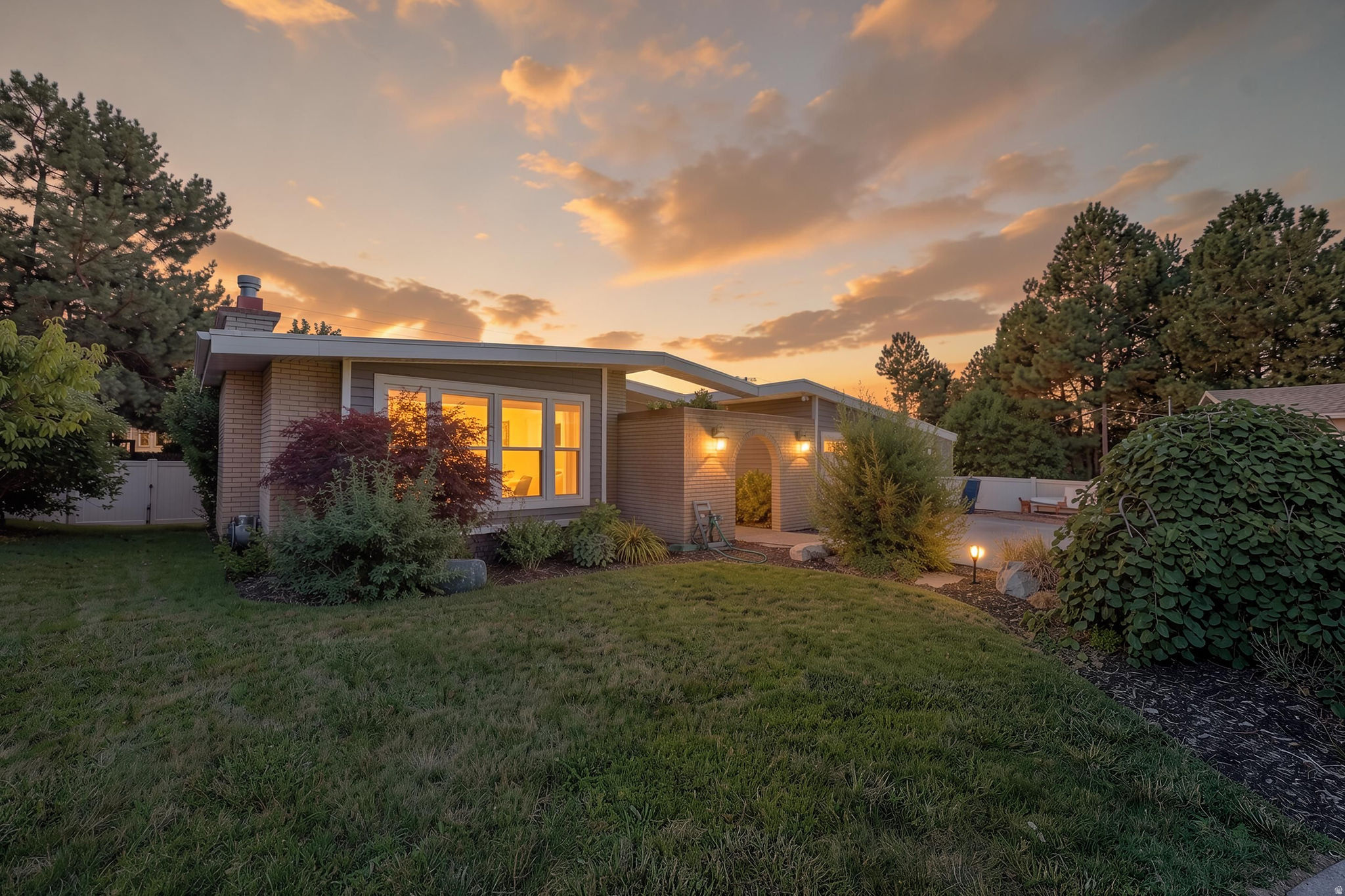 ***OPEN HOUSE | SATURDAY, 7/18 | 12:00 PM - 2:00 PM***  Welcome to this beautifully updated mid-century modern-inspired rambler tucked away on a quiet cul-de-sac in one of Ogden's most desirable locations. Situated on a private, fully landscaped 0.28-acre lot with stunning mountain views, this home offers over 3,100 square feet, 5 bedrooms, and 3 bathrooms, with a versatile floor plan designed for comfortable everyday living and effortless entertaining.  The main level features an inviting open living space with soaring vaulted ceilings that flows seamlessly into the updated kitchen, complete with granite countertops, premium appliances, abundant cabinetry, and generous prep space. The spacious primary suite is conveniently located on the main level, while the fully finished walkout basement offers incredible flexibility.  Downstairs, you'll find a fully equipped Additional Dwelling Unit (ADU)/mother-in-law apartment with its own private entrance, making it ideal for multigenerational living, guests, rental income potential, or a private home office.  Step outside and enjoy your own backyard retreat featuring an expansive 1,000-square-foot paver patio, covered deck, mature landscaping, shade sails, ambient lighting, and plenty of space to entertain or simply relax while taking in the mountain scenery. Additional amenities include radiant in-floor heating, two water heaters, secondary water, RV parking, an attached workshop, and an oversized two-car garage.  Outdoor enthusiasts will love the unbeatable location, just minutes from three world-class ski resorts and several of Northern Utah's most popular lakes, offering year-round adventure with skiing, snowboarding, boating, paddleboarding, fishing, hiking, mountain biking, and more. Conveniently located near Weber State University, the Dee Events Center, shopping, dining, parks, trail systems, and quick freeway access, this home truly combines lifestyle, functionality, and location.  Don't miss the opportunity to make this exceptional property your next home!  Buyer and Buyer's Broker to verify all information. Please submit a pre-approval letter or proof of funds with all offers..