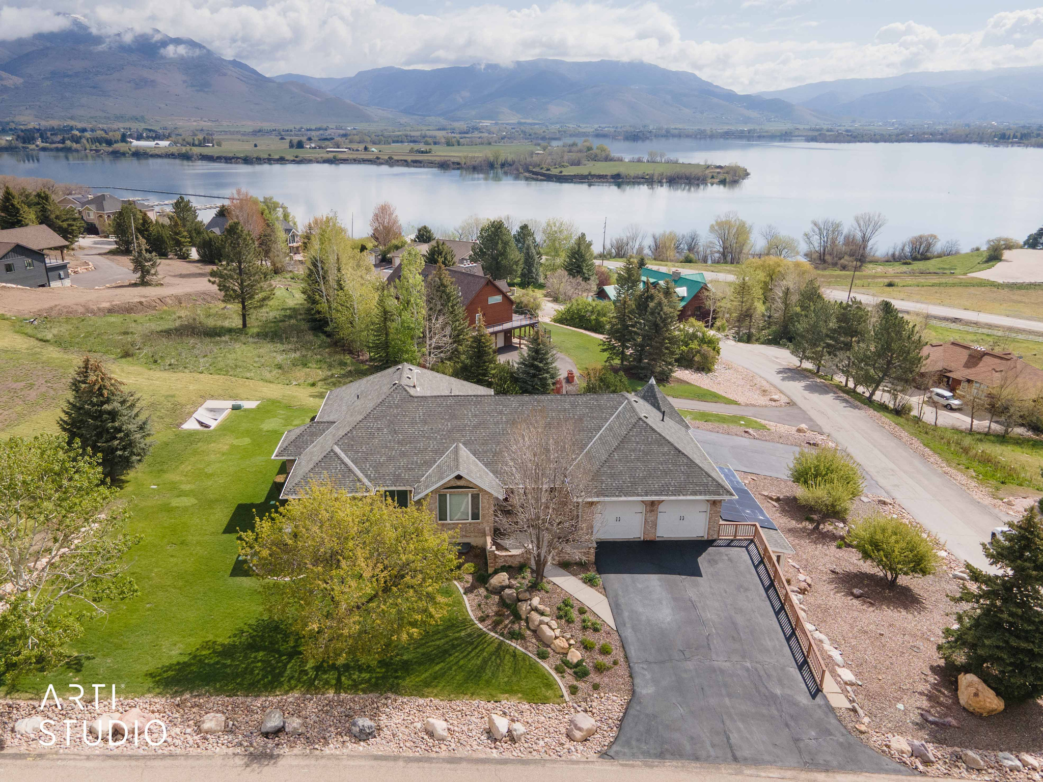 Welcome home to your lakeside retreat with stunning panoramic views of Pineview Reservoir in the heart of Eden, UT, conveniently located across from Port Marina and near world-class recreation. This spacious 5,100+ sq ft home offers 6 bedrooms and 5 bathrooms on over 1 acre of land- thoughtfully designed for everyday living, hosting large family gatherings, and elevated mountain living. This home features generous living spaces, a bright sunroom, and expansive deck and patio areas to take in the incredible views. The 7-car garage and dual driveways provide parking for 20+ vehicles, ideal for guests, recreational vehicles, or multi-generational living. Additional features include a mother-in-law apartment, paid-off solar panels, a Generac backup home generator, radon mitigation system, 2 fireplaces, 2 laundry rooms, and abundant storage throughout. Enjoy easy access to year-round recreation, including hiking and biking trails, world-class ski resorts, Wolf Creek Golf Course, and Pineview Reservoir. Don't miss this rare opportunity to own a truly remarkable property-where luxury, space, and recreation come together in one unforgettable setting. **Text Lakeside to 39200 for additional information and a 3D walkthrough!**