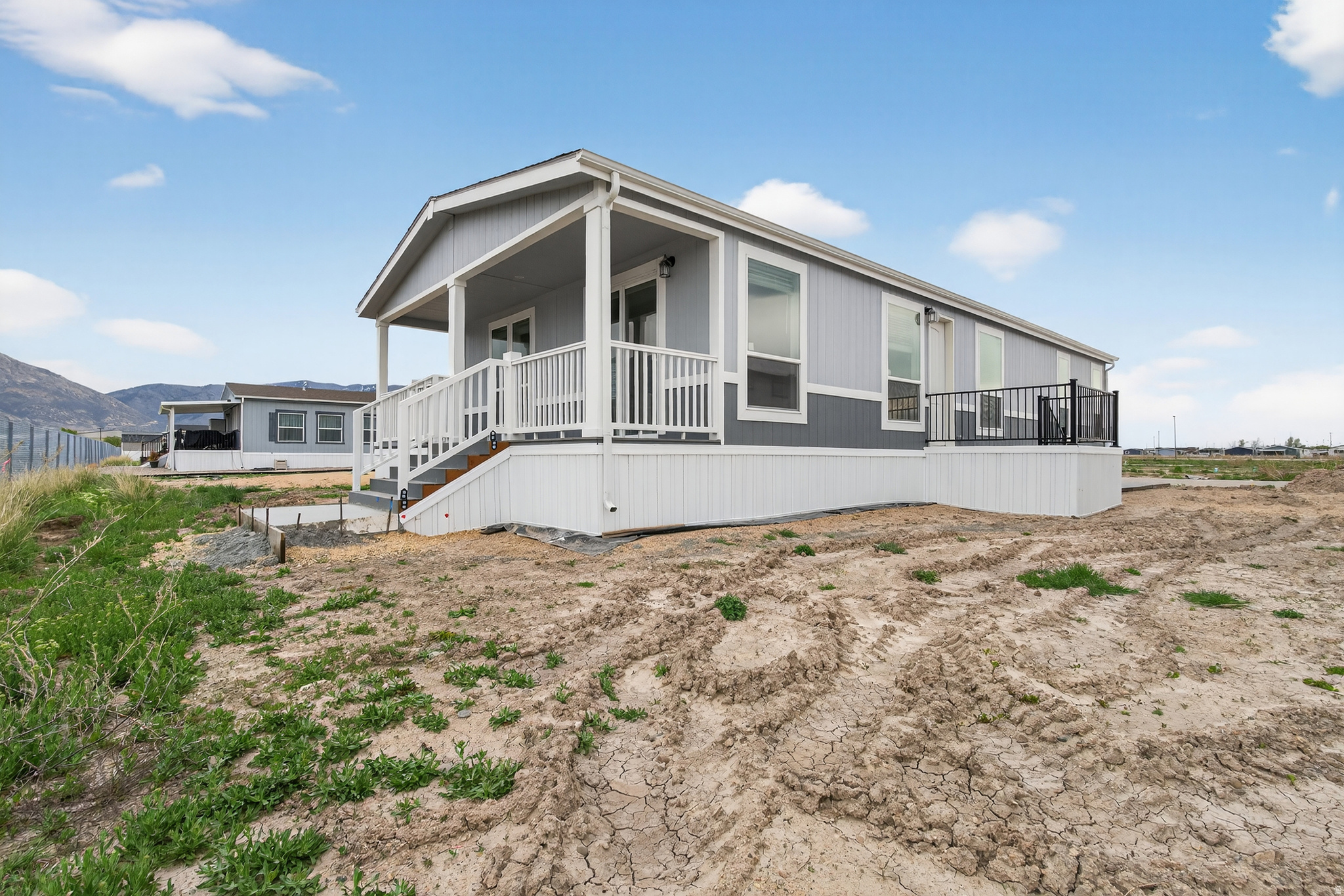 Welcome to the nicest and most upgraded home in the community, a fully custom manufactured home that truly stands apart. This one-of-a-kind floor plan has never been built in this configuration, offering a unique layout and elevated finishes throughout. Designed with comfort and quality in mind, this home features enhanced insulation, a full rear porch (premium upgrade), and an abundance of natural light throughout. The kitchen showcases upgraded cabinetry, custom color selections, and a modern, high-end feel. A flexible living space has been thoughtfully designed as a den or optional bedroom, giving you added versatility. Situated on the back row of the community, this home offers rare privacy with no rear neighbors and stunning views of Ben Lomond Peak. If you're looking for something truly special, this is not your average manufactured home-this is a fully customized, one-of-one opportunity you won't find anywhere else. Square footage figures are provided as a courtesy estimate only and were obtained from manufacturer plans. Buyer is advised to obtain an independent measurement.