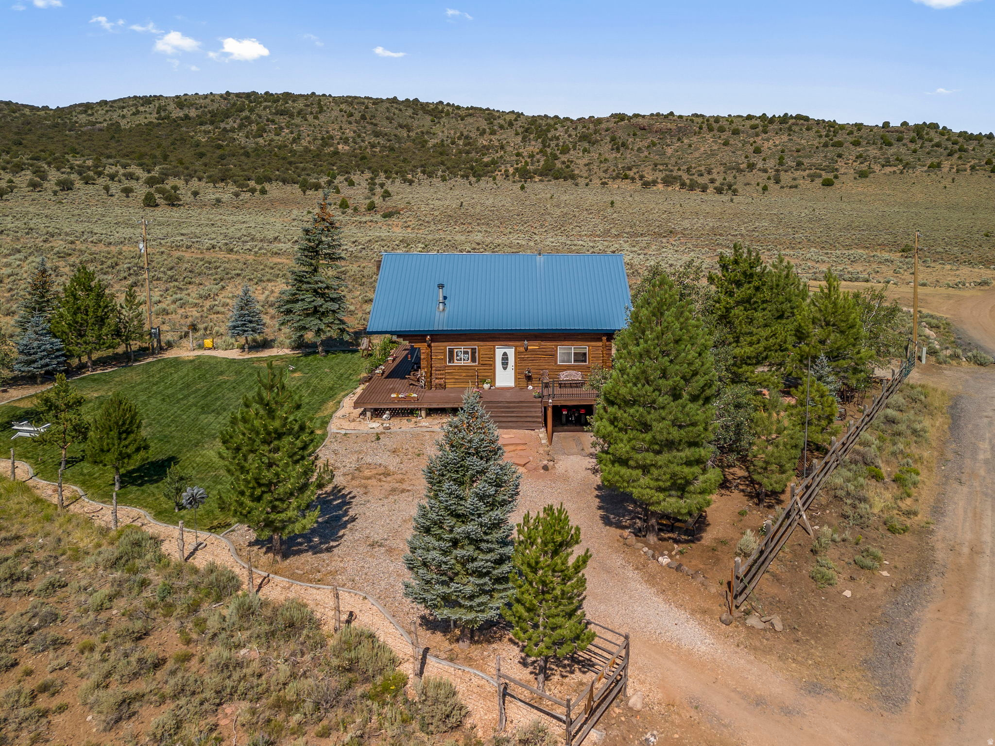 This amazing view comes with a cabin!! You wont' believe how peaceful, serene and quaint this fantastic 2 bedroom, 1 bathroom log cabin really is. Located in Pine Valley Ranchos. Backs to forestry land with gated access for off road adventures. Space under the cabin will hold Off Road vehicles and has a built in work shop. Decks on three sides. Come take a look, sit on the front deck and smell the trees, take in the fresh mountain air and relax. Great for a 2nd home, family retreat or full time living.