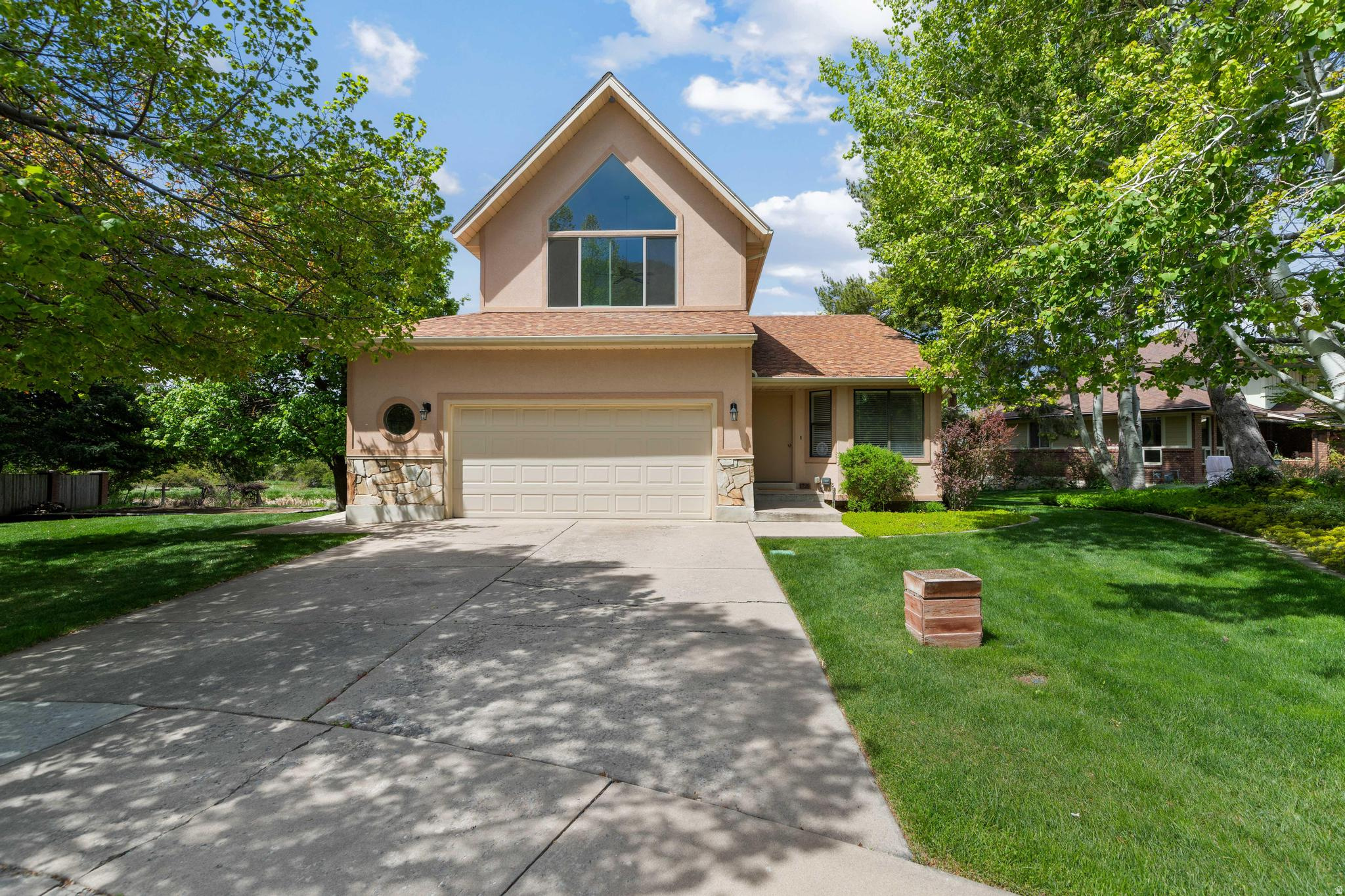 This well-built, custom home features a spacious floor plan with vaulted ceilings on the main level and in the master suite. The kitchen offers a breakfast nook with views of the yard, garden plot, canal with resident ducks, and beautiful trees, creating a peaceful setting. Large windows and a sliding back door enhance the inviting, oasis-like atmosphere.  With 4 bedrooms and 3 bathrooms (one bedroom used as a versatile work/hobby space), the home is designed for practicality, featuring ample storage and a garage basement entrance.  A newer boiler system was added for comfort, the interior was repainted in recent years, and the stucco was completely replaced in 2016.  Enjoy the walk-out basement with access to a large, wired patio, ideal for a hot tub. Additional features include surround sound, automatic sprinklers, LeafFilter gutters, walk-in closets, and a spacious laundry room with built-in ironing and folding tables, generous storage closets, and a laundry sink.  Located on a quiet cul-de-sac, with a canal flowing in the backyard, this home combines luxury and tranquility-making it the perfect retreat. Schedule your visit today.