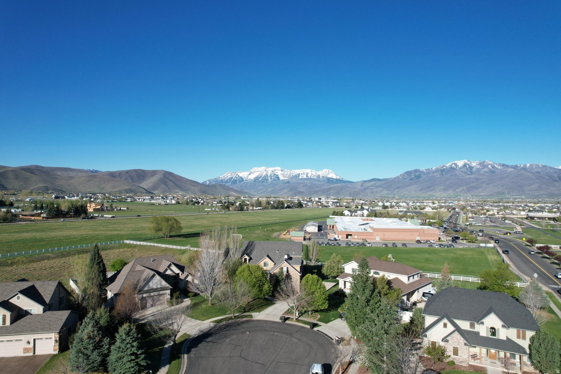 Placed on the best view lot in the sought-after Cobblestone neighborhood -- with community open space, walking trails, parks, and convenient proximity to schools and churches -- this exceptional home offers a setting that's hard to beat. The main level delivers elevated living with incredible Timpanogos views, a master suite featuring a large walk-in closet and separate tub and shower, an open great room anchored by an marble fireplace, double ovens, gas stove, sunroom, mudroom, and dedicated laundry. Upstairs offers two bedrooms, a full bath, and a bonus room. The lower level functions as a complete second living space -- two bedrooms, full bath, kitchen, great room with fireplace, and semi-formal dining, ideal for multigenerational living or guests. Thoughtful mechanicals include solar panels, tankless water heater, water softener, four-zone HVAC, and radon mitigation. Finishing touches like an imported front door, epoxy garage floor, and a pergola with outdoor dining area speak to the care put into every detail. Best of all -- enjoy unobstructed views of Mount Timpanogos, the finest in the neighborhood, from a home that adjoins the schoolyard for added open space and privacy.