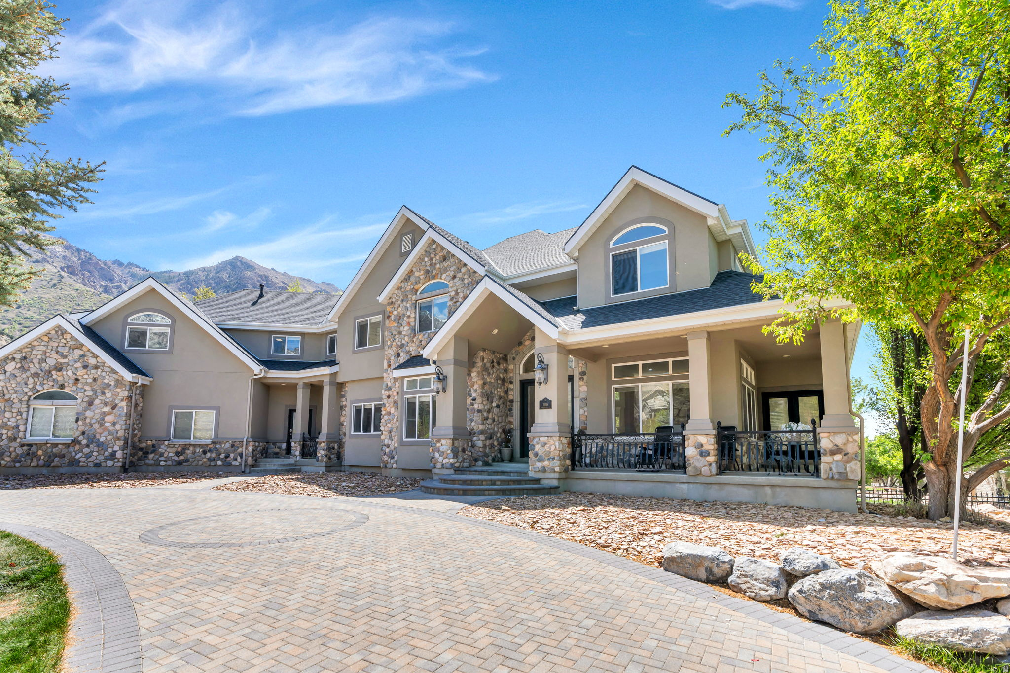 Introducing a rare and refined Alpine estate where privacy, scale, and possibility converge. Tucked discreetly at the end of a quiet cul-de-sac and framed by the natural beauty of the Wasatch Mountains, this exceptional property offers an elevated lifestyle defined by space, serenity, and long-term vision. Set across nearly 1.2 acres-including a highly coveted, buildable secondary parcel-this offering presents a true legacy opportunity. Whether envisioned as a multi-generational compound, a resort-style retreat, or a custom expansion tailored to your lifestyle, the land itself is as valuable as the residence it complements. The home spans approximately 7,900 square feet and is thoughtfully designed to accommodate both grand entertaining and comfortable everyday living. With seven bedrooms and four bathrooms, the layout offers flexibility, scale, and functionality. Light-filled interiors, expansive living areas, and multiple gathering spaces create a sense of openness, while the home's positioning maximizes privacy and connection to the surrounding landscape. A dedicated media room-complete with a podcast-ready stage and green screen-introduces a modern, creative dimension rarely found in Alpine estates, offering unique versatility for today's lifestyle. Outdoors, the property unfolds into a private sanctuary. Mature landscaping, a tranquil water feature, and a pond create a peaceful, established setting, while open space invites future customization. The additional parcel unlocks possibilities that are increasingly rare in this market: a guest house or ADU, pool and pool house, sport court, equestrian facilities, or a curated garden estate. Zoned for up to two horses, the property seamlessly blends luxury living with rural elegance. Unlike many legacy homes in the area, this residence presents a clean, modern aesthetic-positioning it alongside newer luxury inventory while offering significantly more land and flexibility. Recent improvements include a new roof installed in 2025 with a 25-year warranty. The home has been intentionally presented as a clean canvas, allowing a discerning buyer to tailor finishes and updates to their exact vision. Surrounded by Alpine estates valued well into the $3 million range and beyond, this property represents both immediate lifestyle appeal and meaningful long-term upside. Located in one of Utah County's most prestigious communities, the home offers close proximity to top-rated schools, world-class outdoor recreation, and the thriving Silicon Slopes corridor-delivering both convenience and exclusivity.This is more than a residence. It is a rare opportunity to define your own estate, in a setting where privacy meets possibility and vision becomes reality.